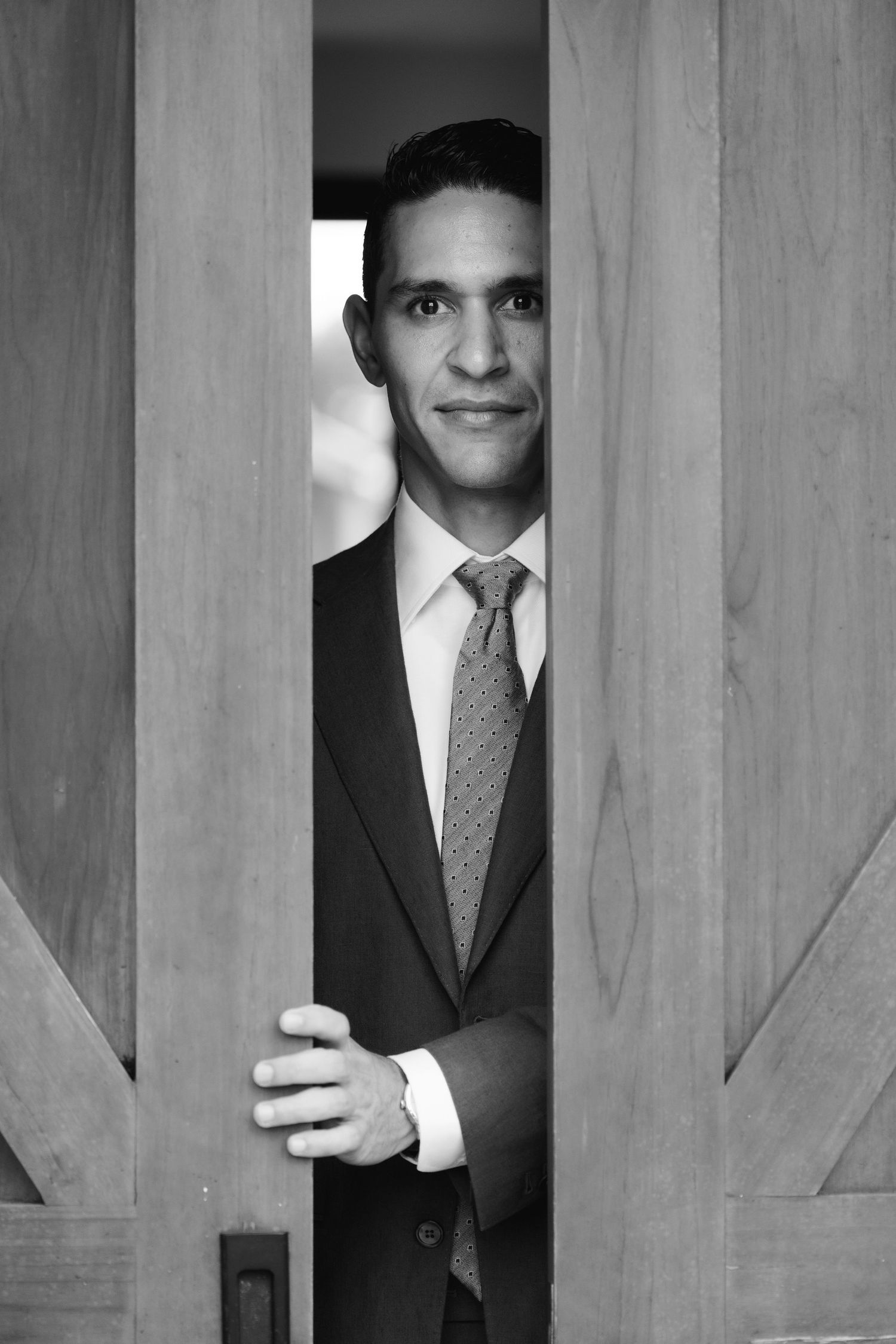 Artistic portraits through wooden slats showing formal attire and tie.