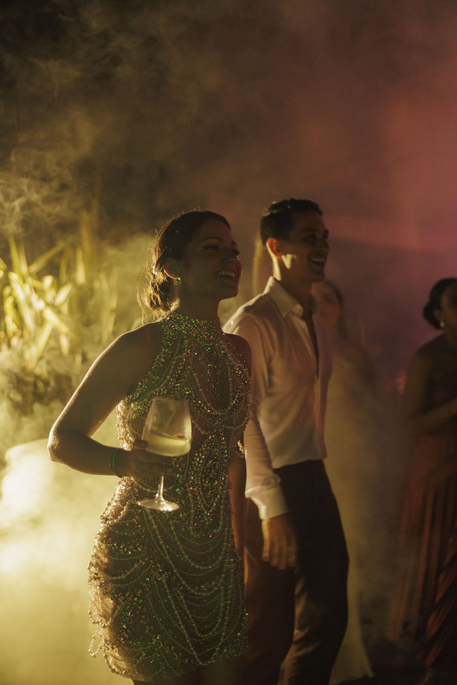 Dancers performing in atmospheric fog with dramatic lighting effects.