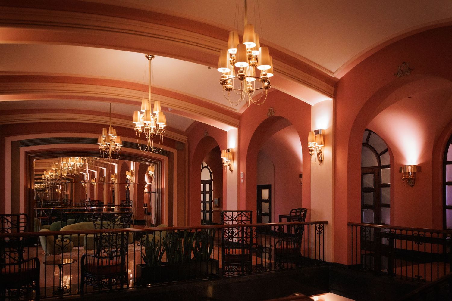 Elegant ballroom with arched ceilings, crystal chandeliers and warm lighting creating a romantic ambiance.