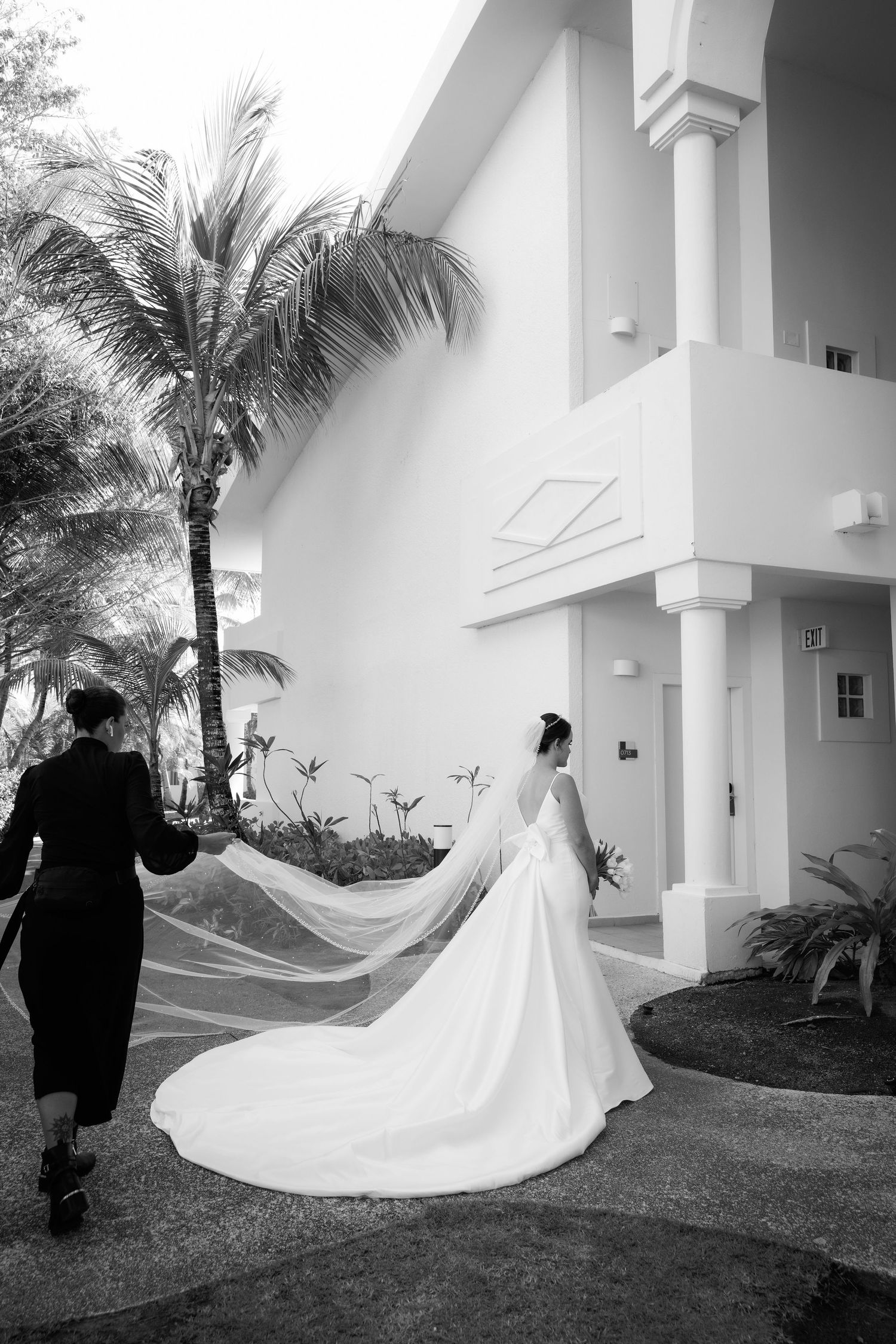 A sequence of artistic black and white wedding photos capturing the dramatic movement of a flowing bridal veil outdoors.
