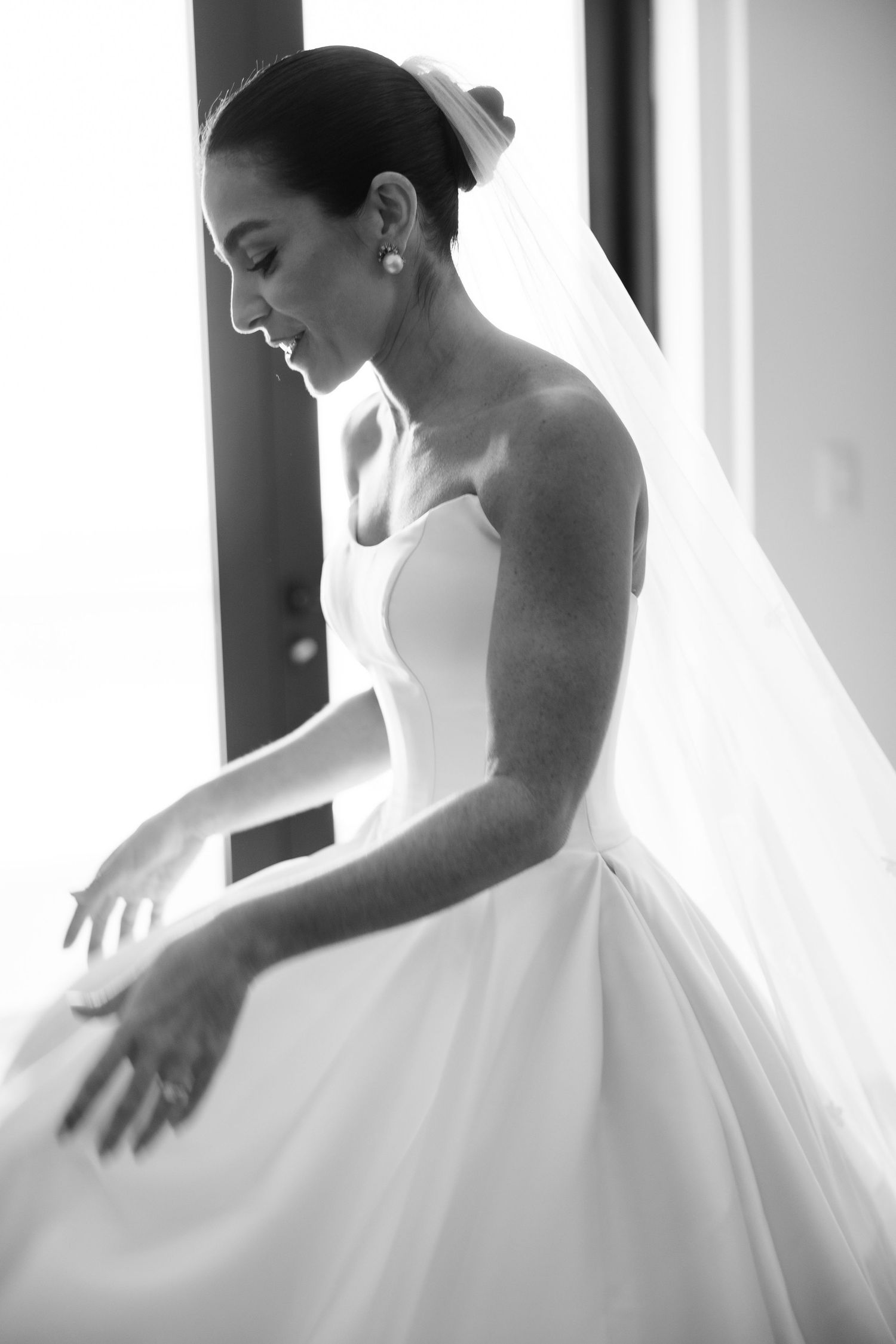 A series of elegant black and white photos showing the flowing movement of a white wedding gown.