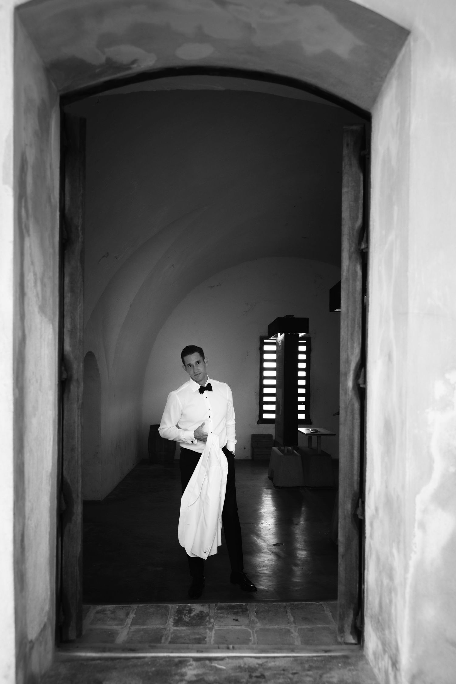 Black and white architectural composition with arched doorways and dramatic lighting.