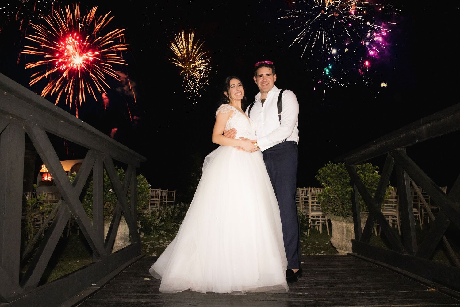 Fireworks display illuminating the night sky in bright red and gold bursts against dark background.
