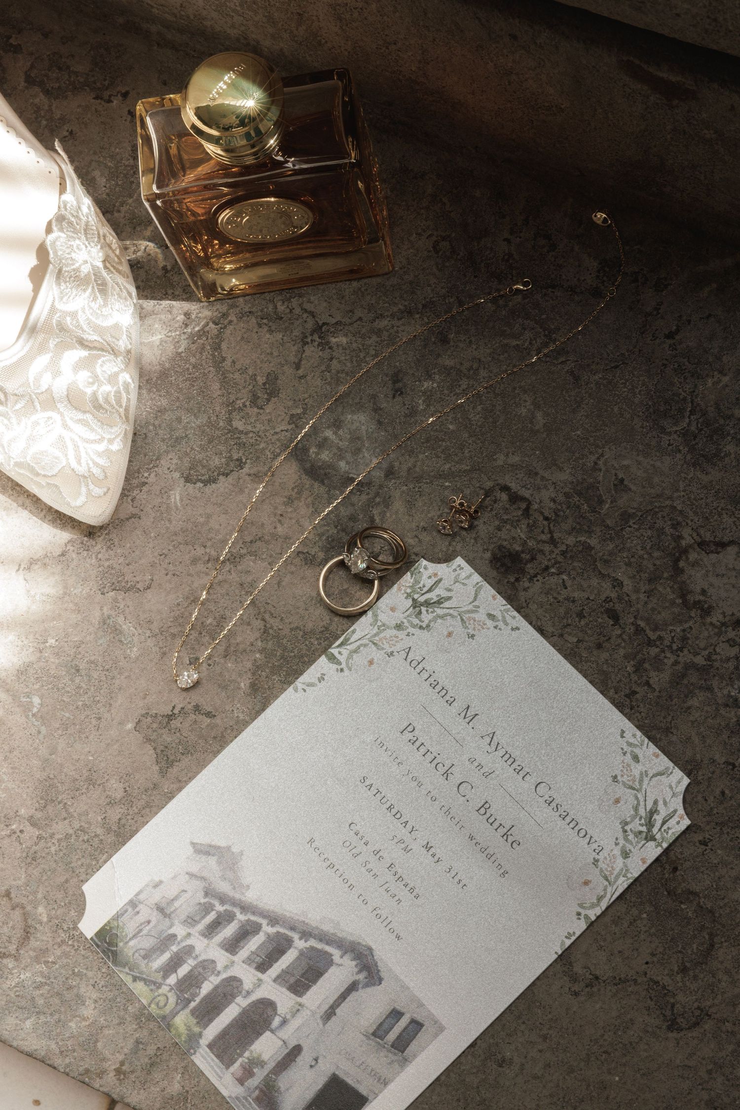 Multiple views of a vintage wedding invitation or card lying on a dark textured surface.