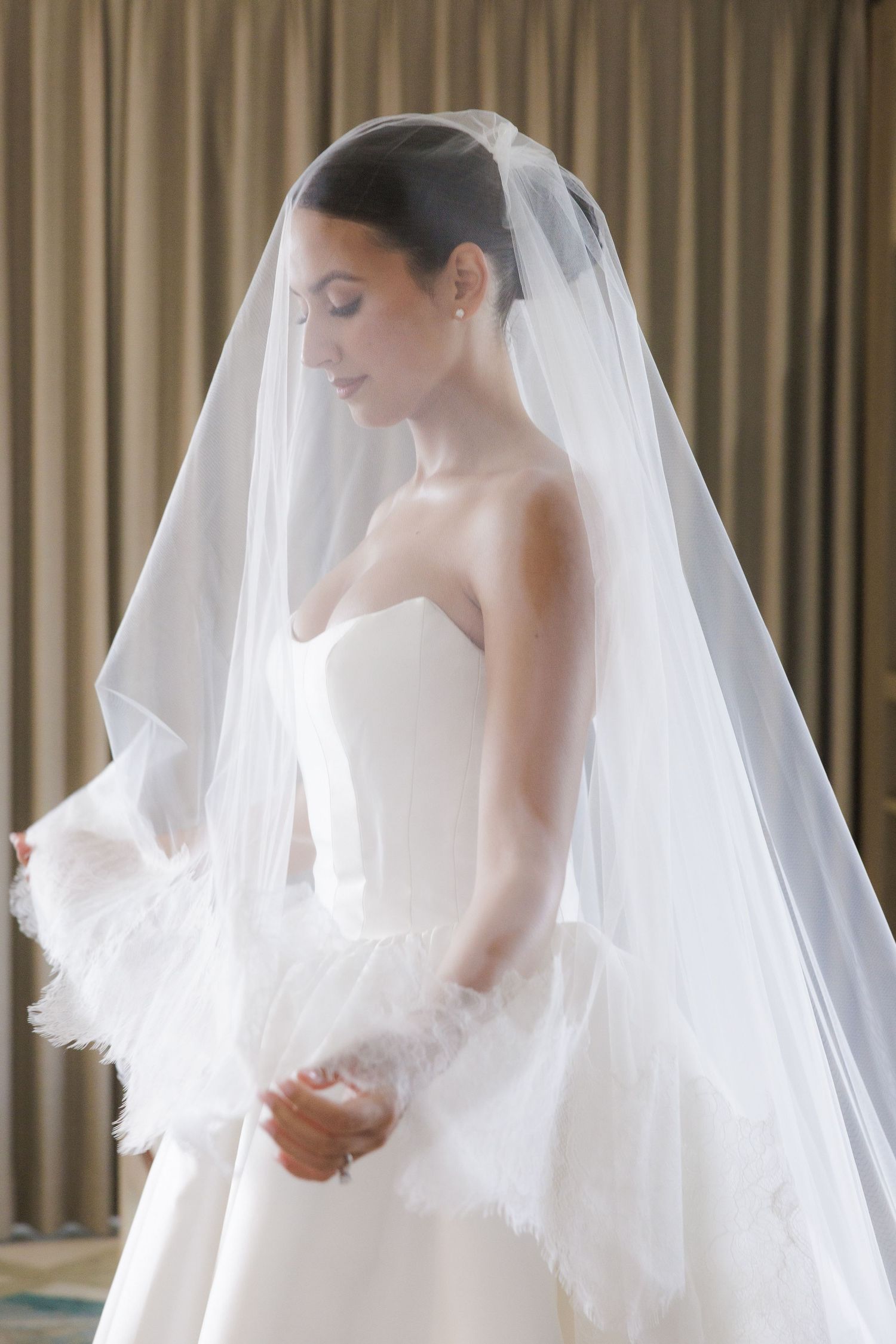Ethereal bridal portraits showing delicate details of a cathedral length veil and classic white gown.