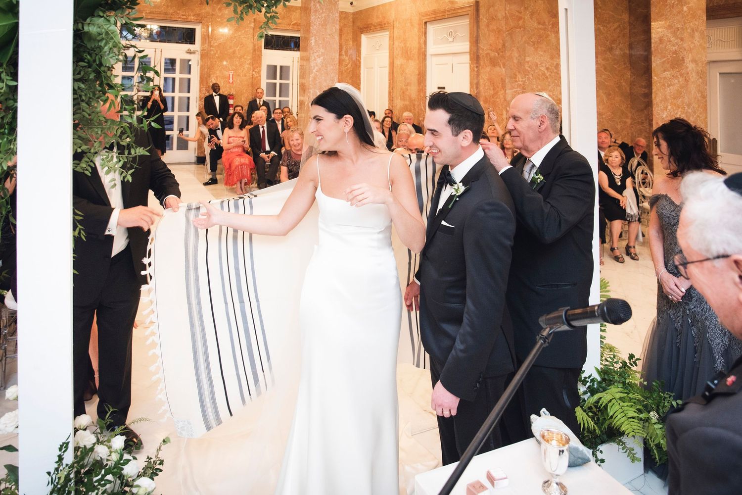 Joyful moments captured at an elegant indoor wedding reception with dancing and celebration.