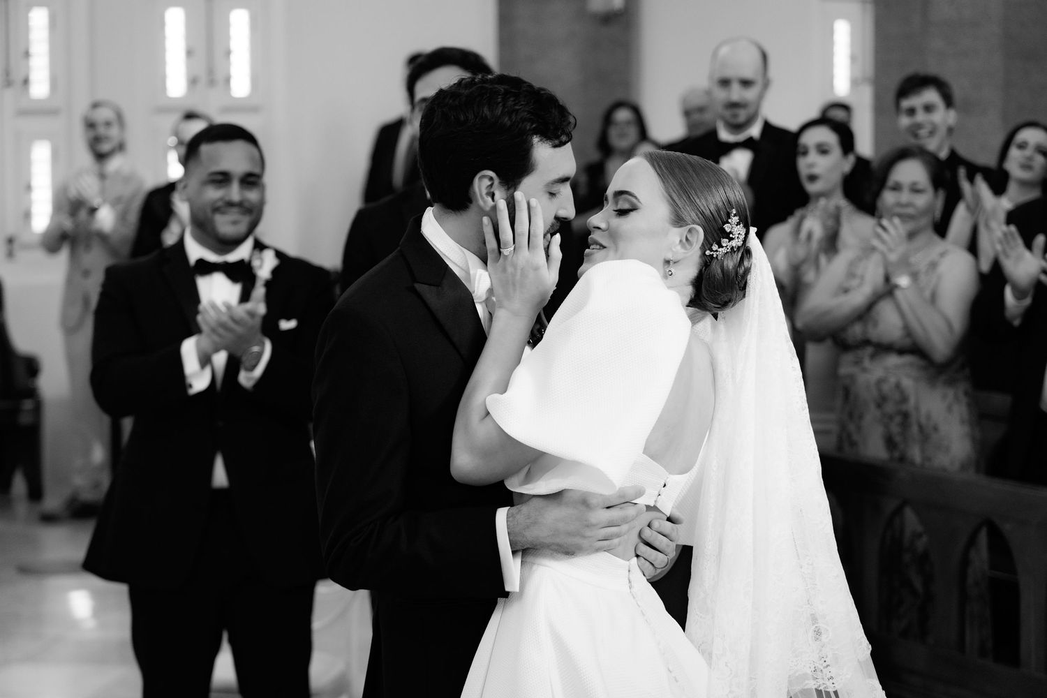 Wedding guests dance and celebrate during a black and white reception party on the dance floor.