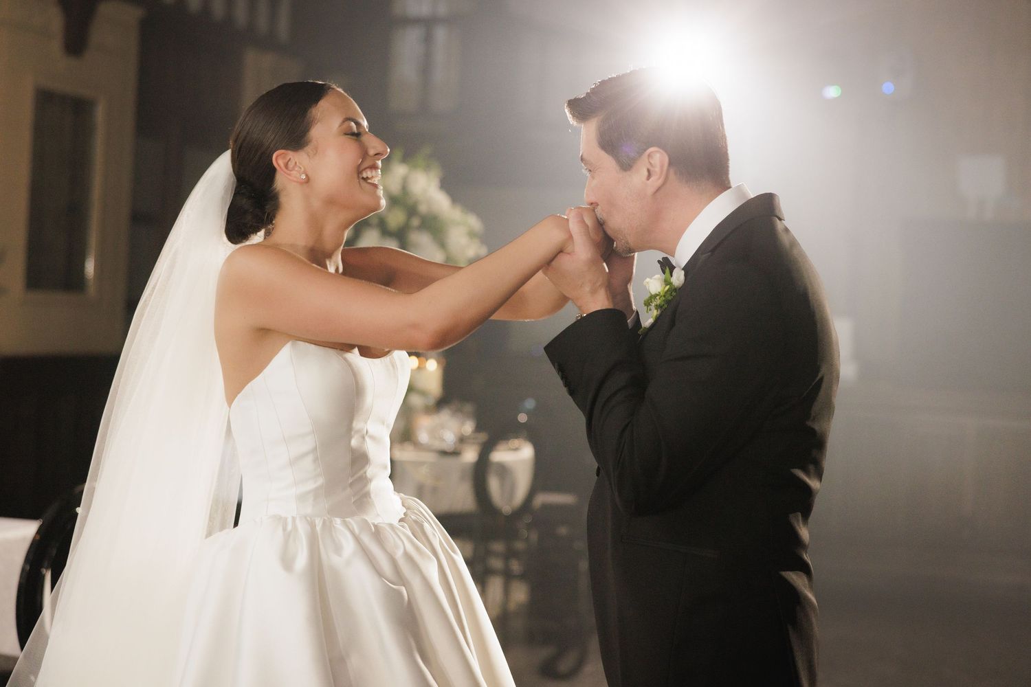 Romantic dance moments captured in soft lighting at an elegant wedding reception.