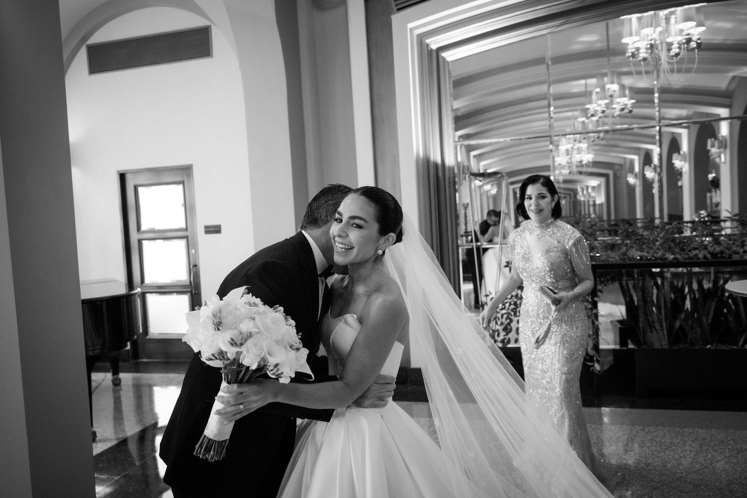 A sequence of black and white wedding photos showing dress fittings and romantic moments in a bridal salon.