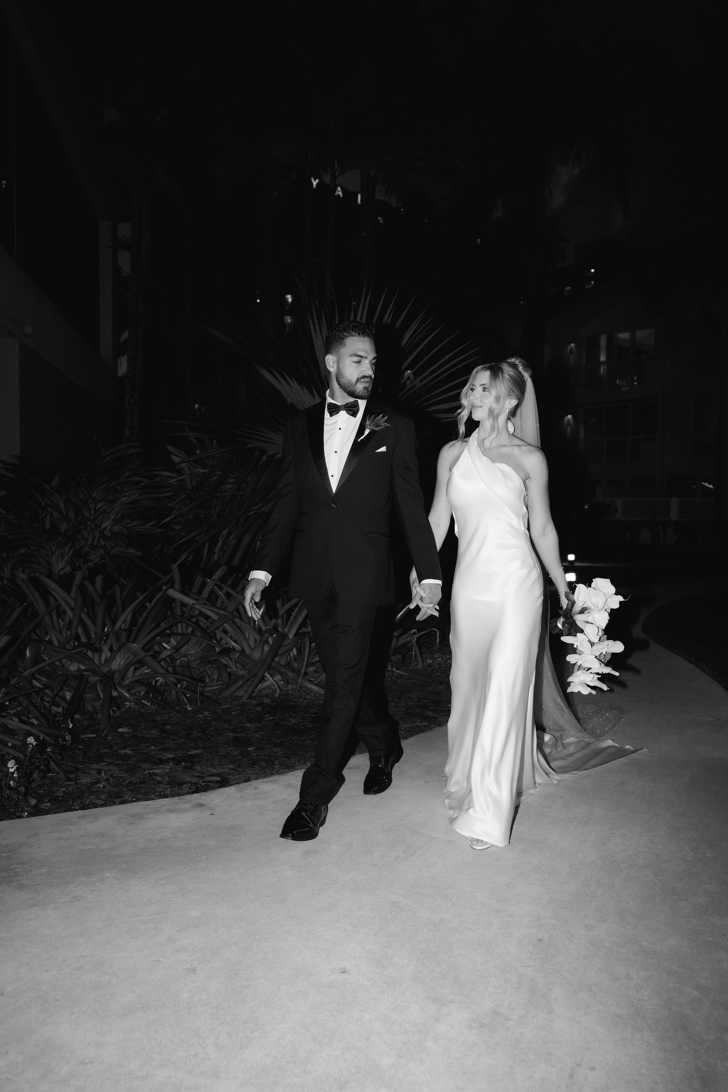 Black and white photo sequence of newlyweds walking together at night during their wedding reception celebration.