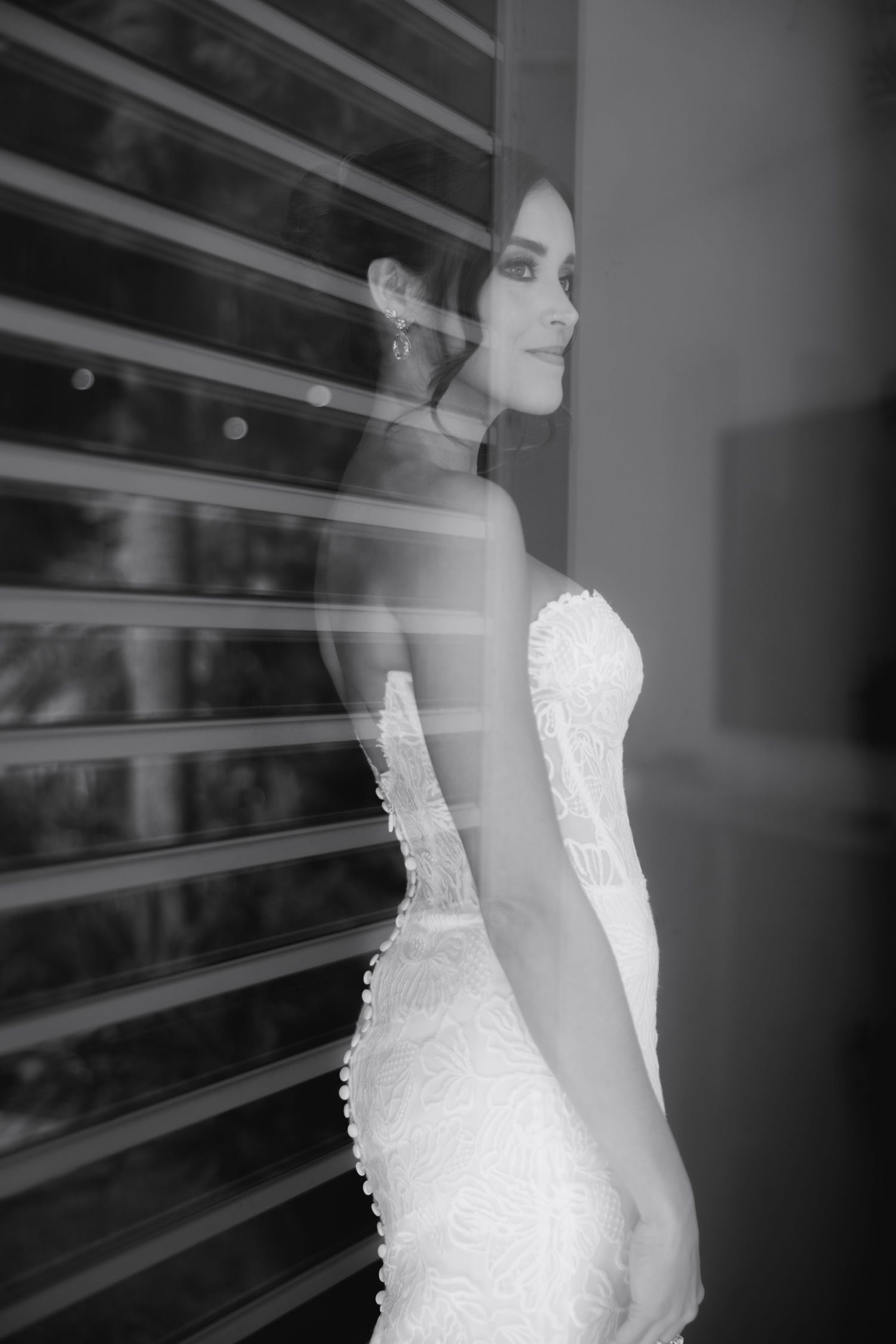 Artistic black and white portrait series showing details of strapless lace wedding gown.