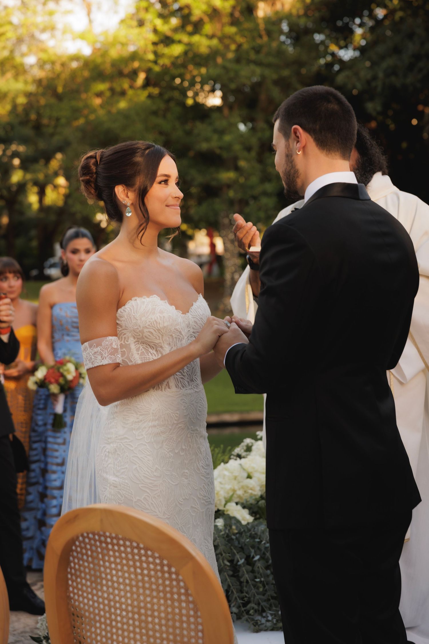 Wedding ceremony at sunset with guests watching the couple's special moment.