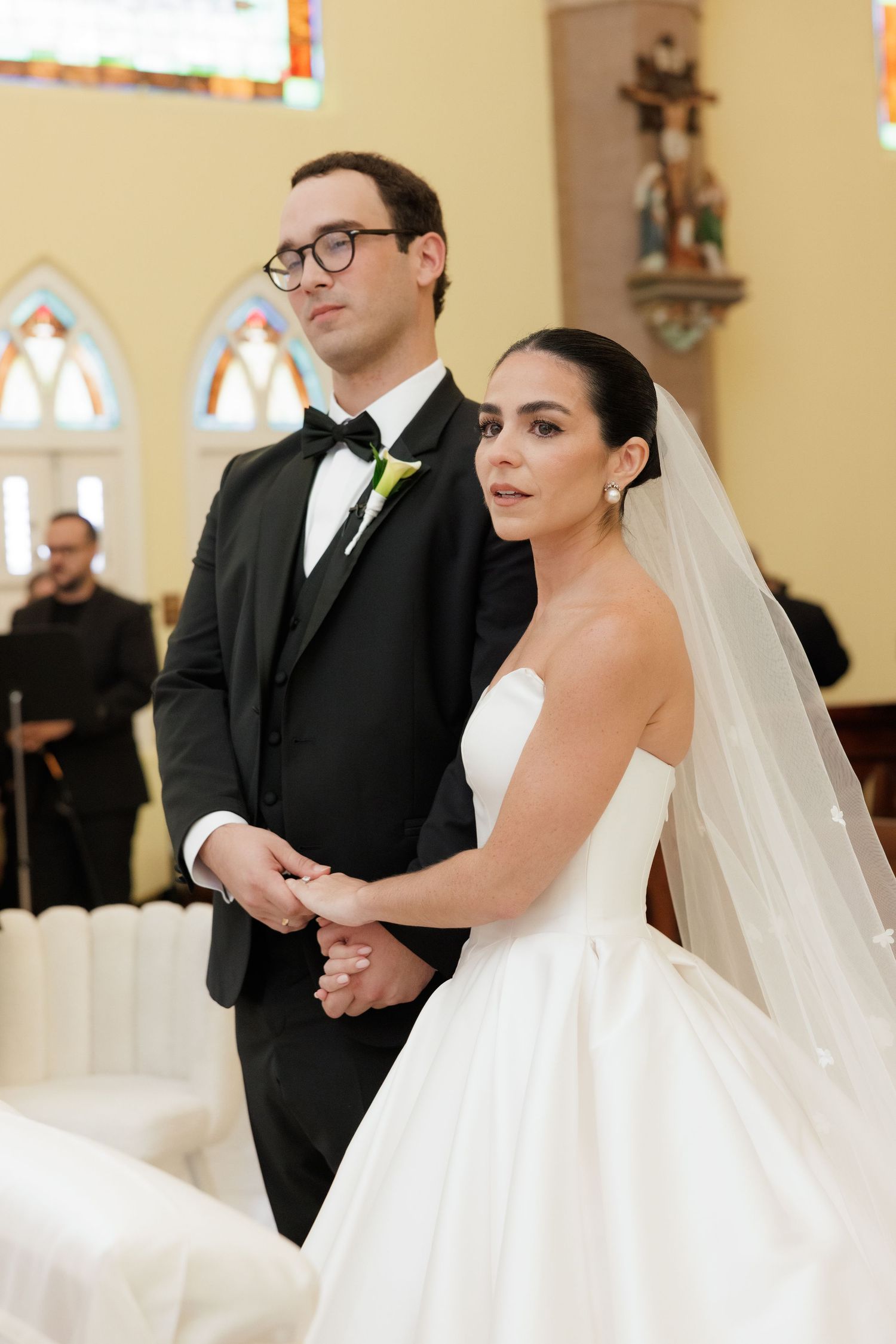 A couple stands at the altar during their traditional church wedding ceremony.