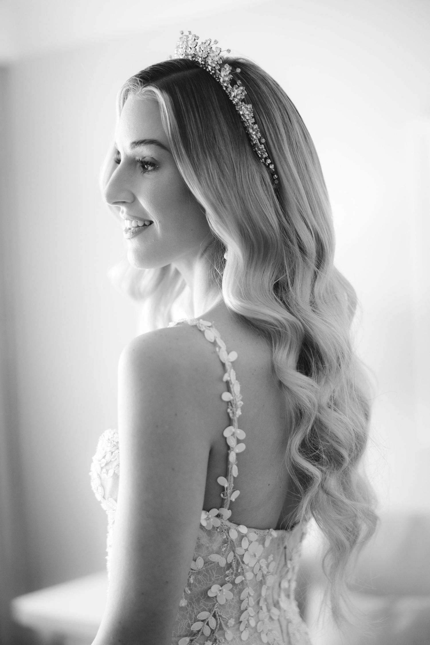 Black and white bridal portraits showcase ethereal natural light with cascading waves and delicate floral accents.