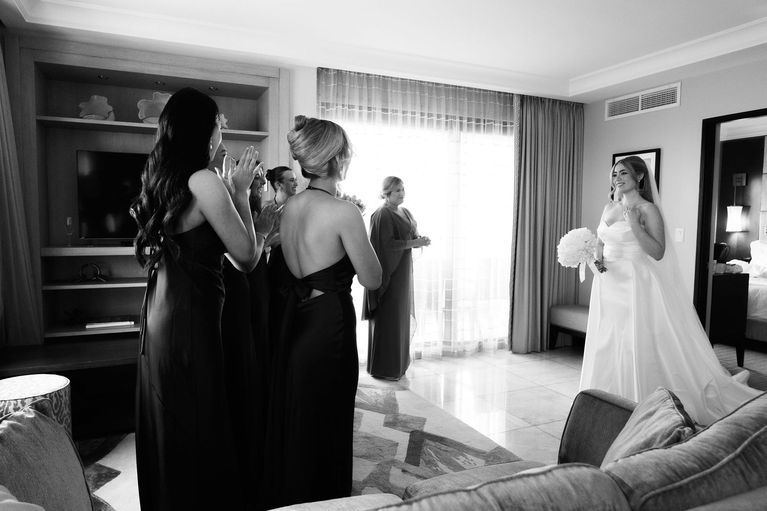 A sequence of black and white wedding preparation photos showing moments before the ceremony in a hotel room.