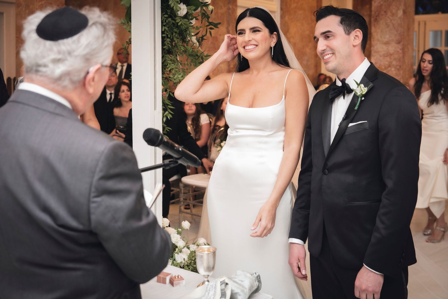A collection of candid wedding moments shown in black and white photographs of couples and guests at a celebration.