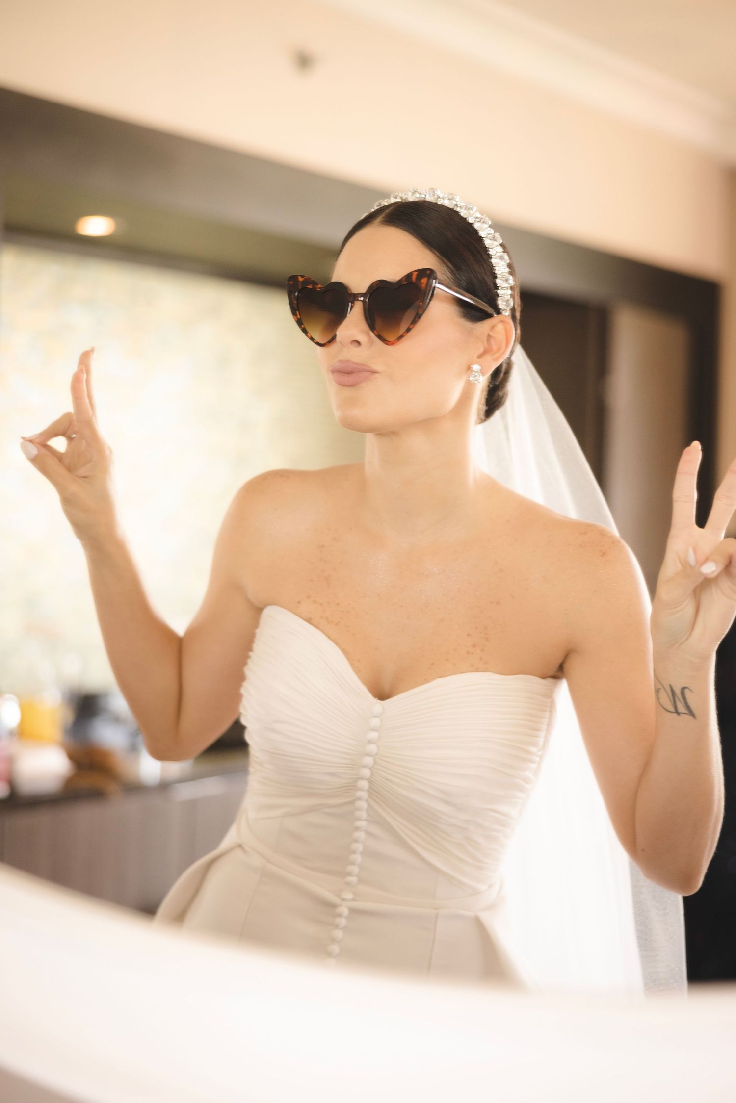 Four-part photo series shows a stylish bride in a white strapless wedding gown wearing retro cat-eye sunglasses.