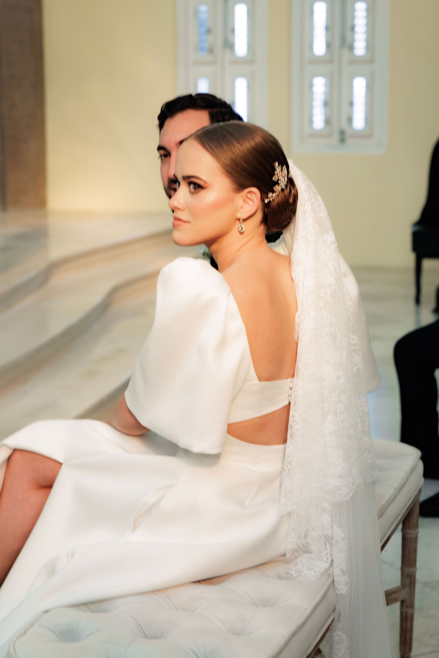 An elegant white wedding dress and veil captured in a series of artistic profile portraits in a church setting.