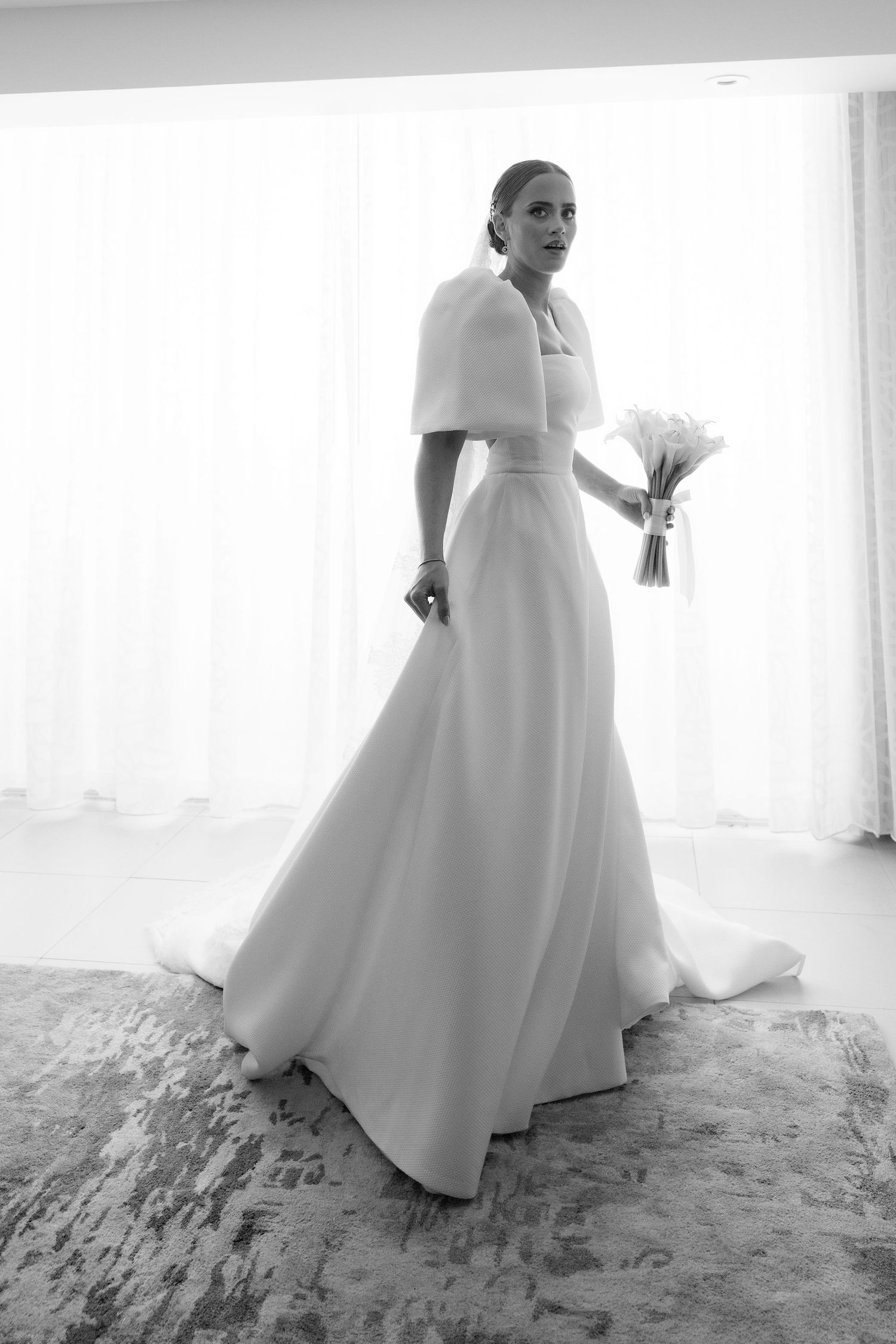 Black and white artistic photo sequence of a bride in an elegant white dress posing by a window in natural light.