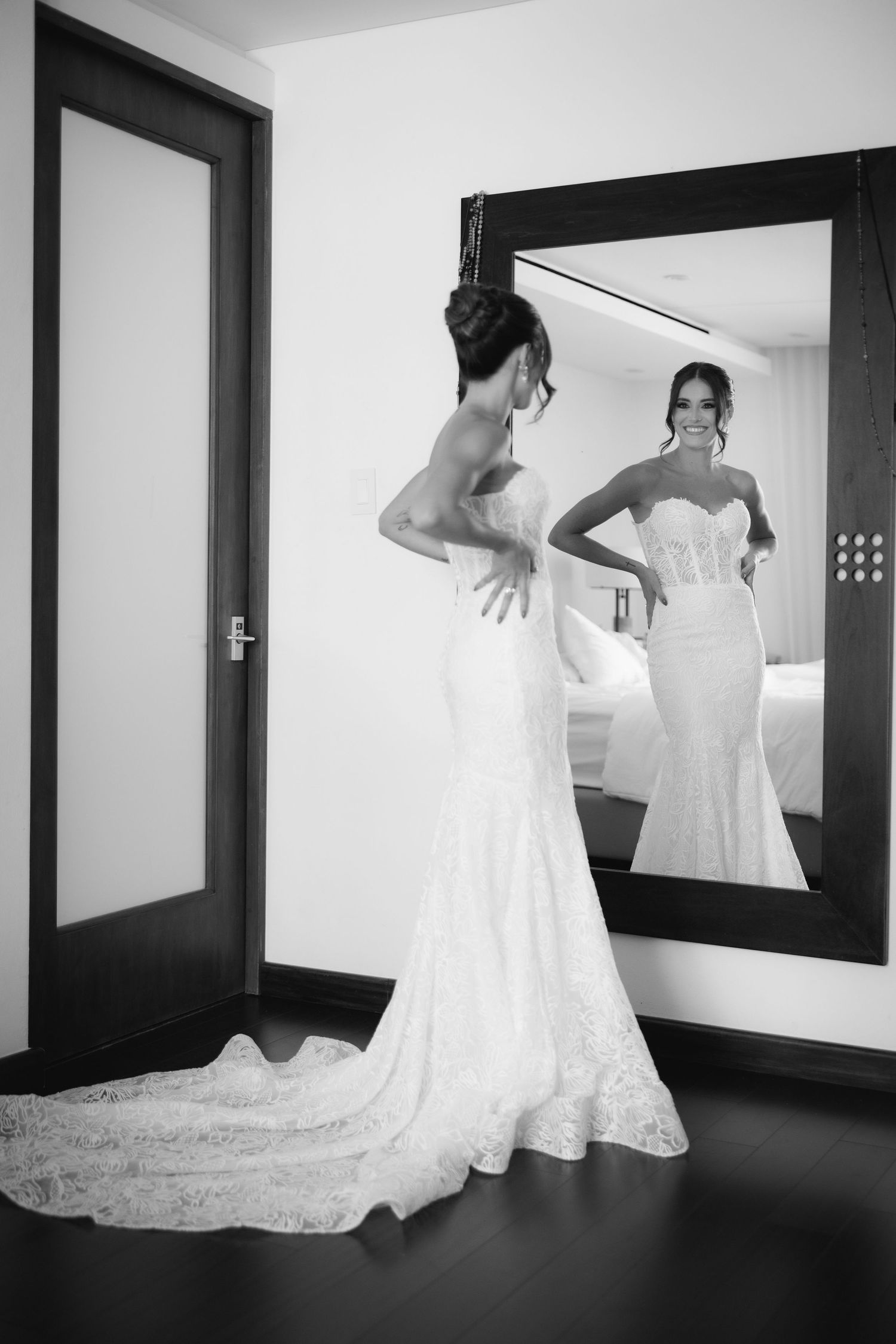 Black and white artistic sequence showing the flowing movement of a wedding dress train against a dark hallway.