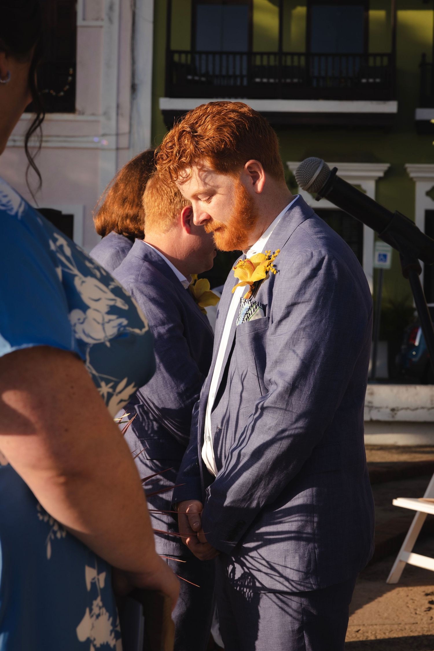 Wedding guests gathered in formal attire during an outdoor celebration.