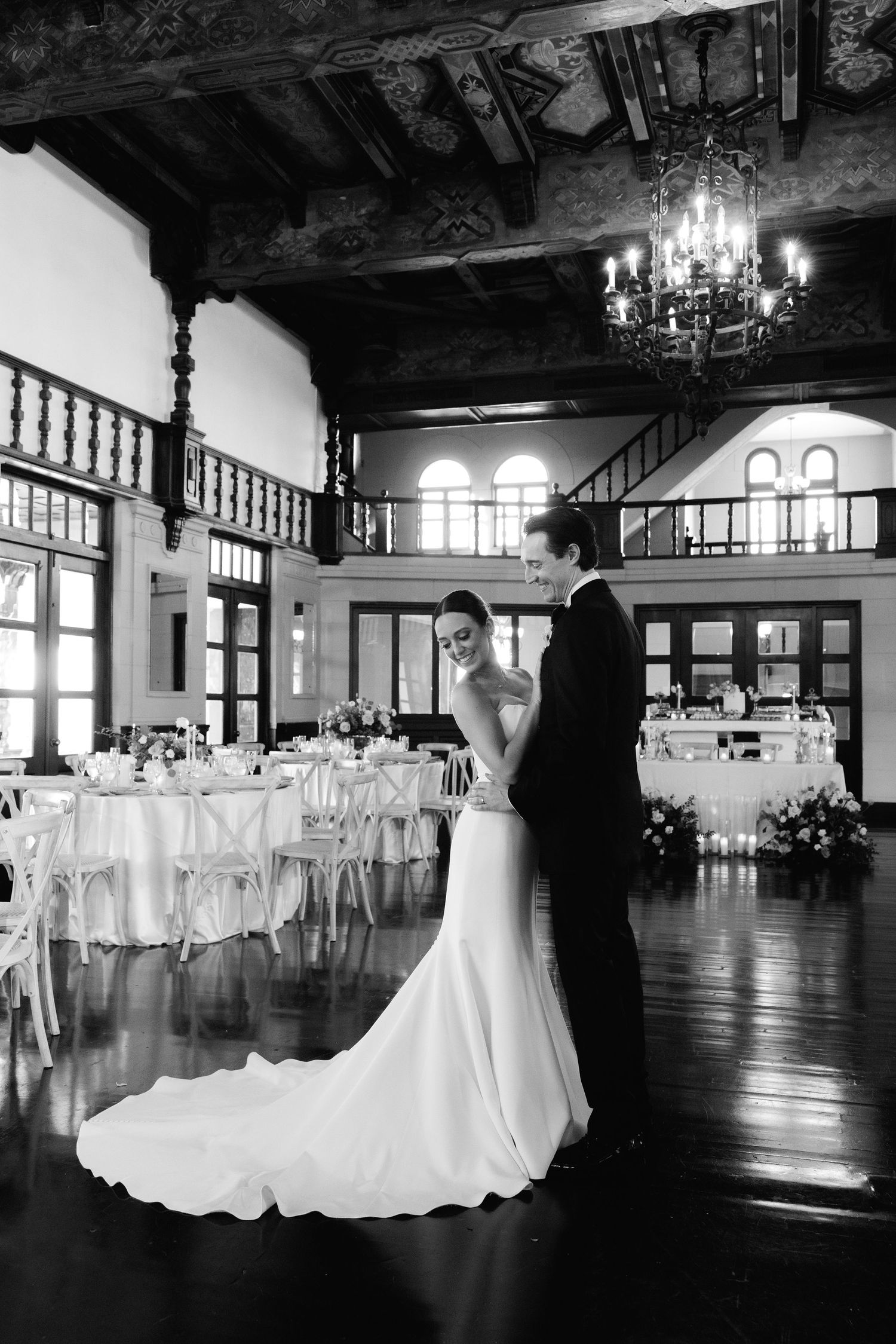 Elegant black and white ballroom dance sequence featuring bride and groom in a grand reception hall.