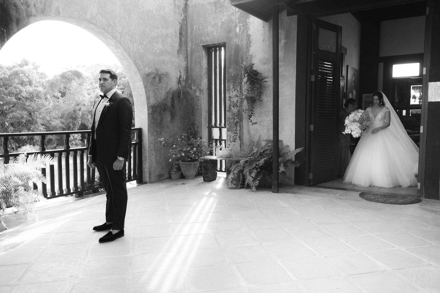 A series of black and white wedding photos showing couples during special moments at their ceremony and portraits.