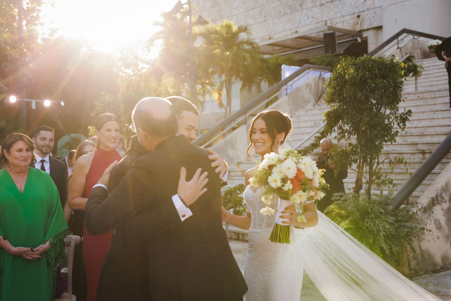 Friends gather at an outdoor garden party with string lights and glowing sunset ambiance.