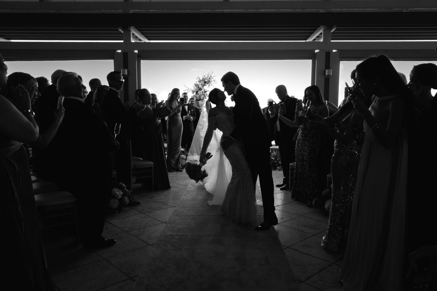Black and white high contrast photos showing silhouettes of people walking in various urban environments and spaces.