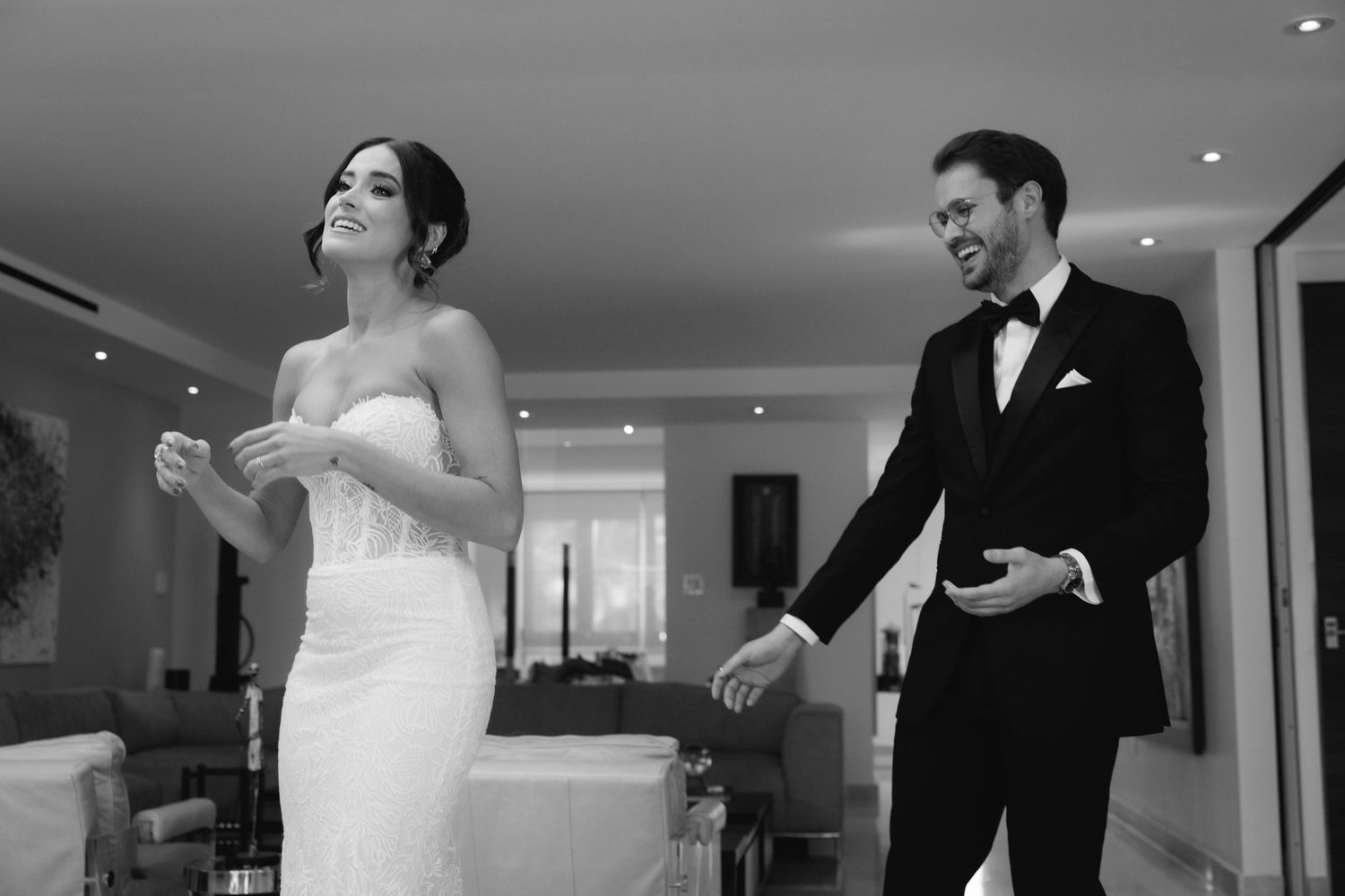 A couple in wedding attire share their first look moment in a series of emotional photographs.