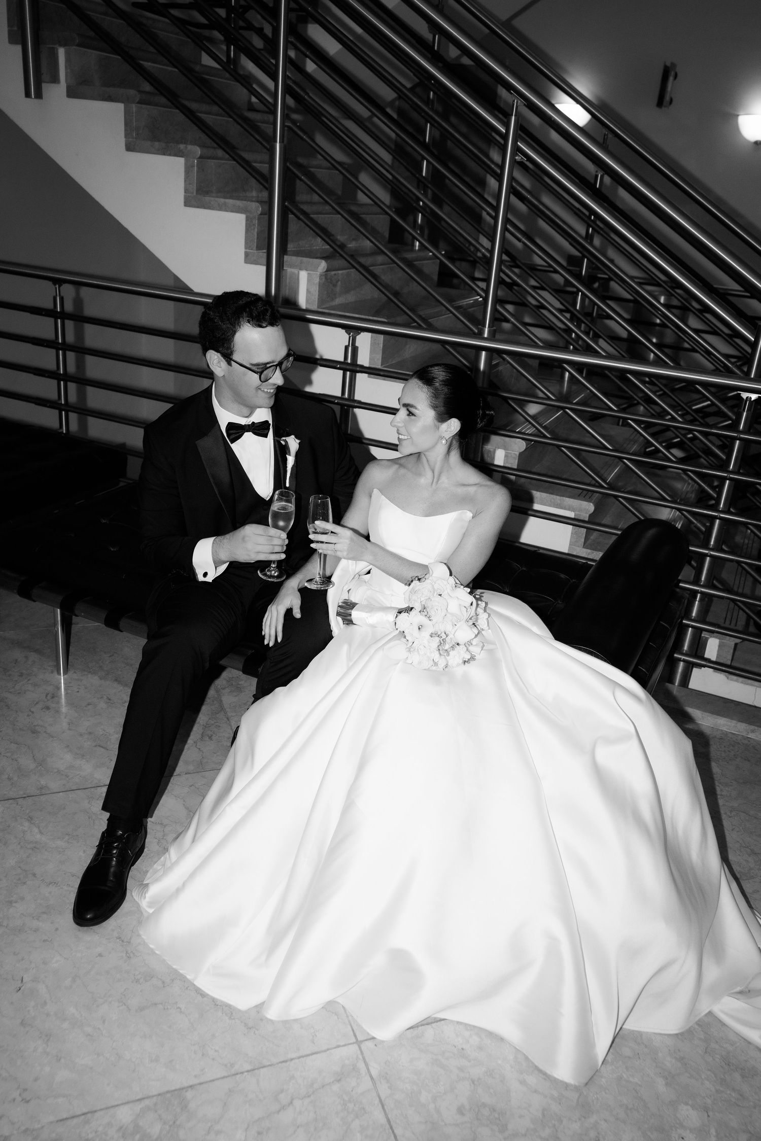 A black and white wedding photo sequence shows a couple dancing with the bride's white dress flowing gracefully.