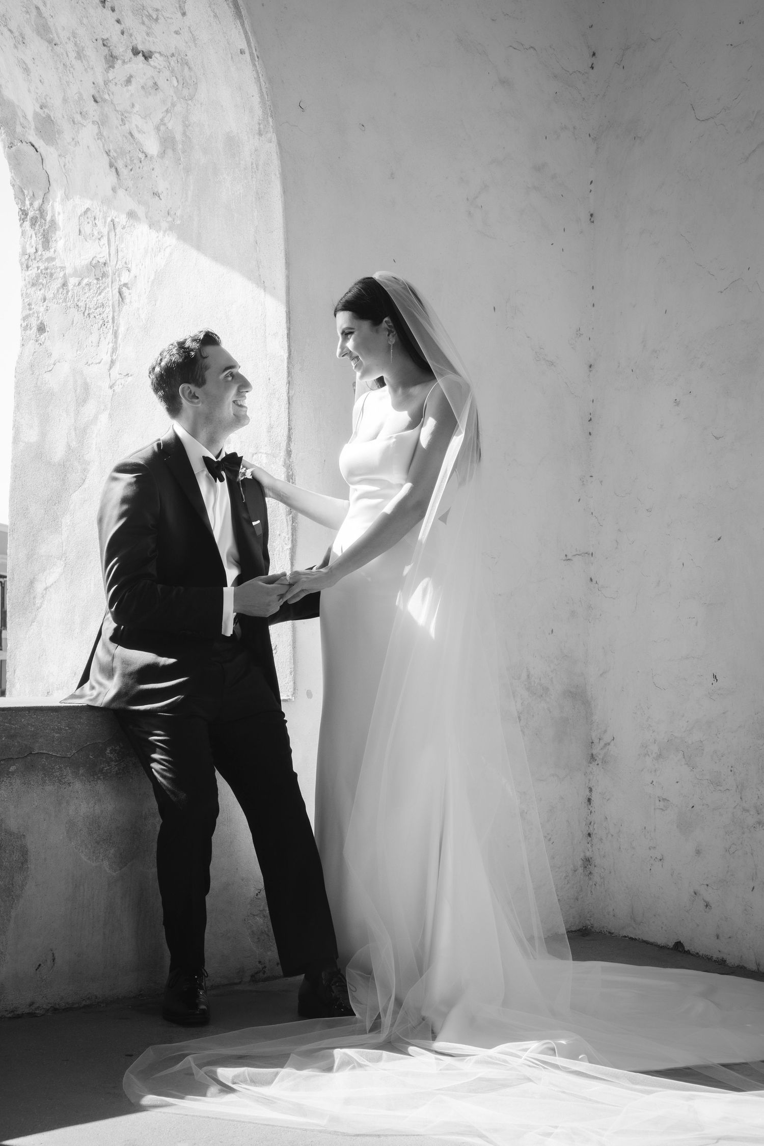 Black and white series of intimate wedding moments in rustic stone interior.