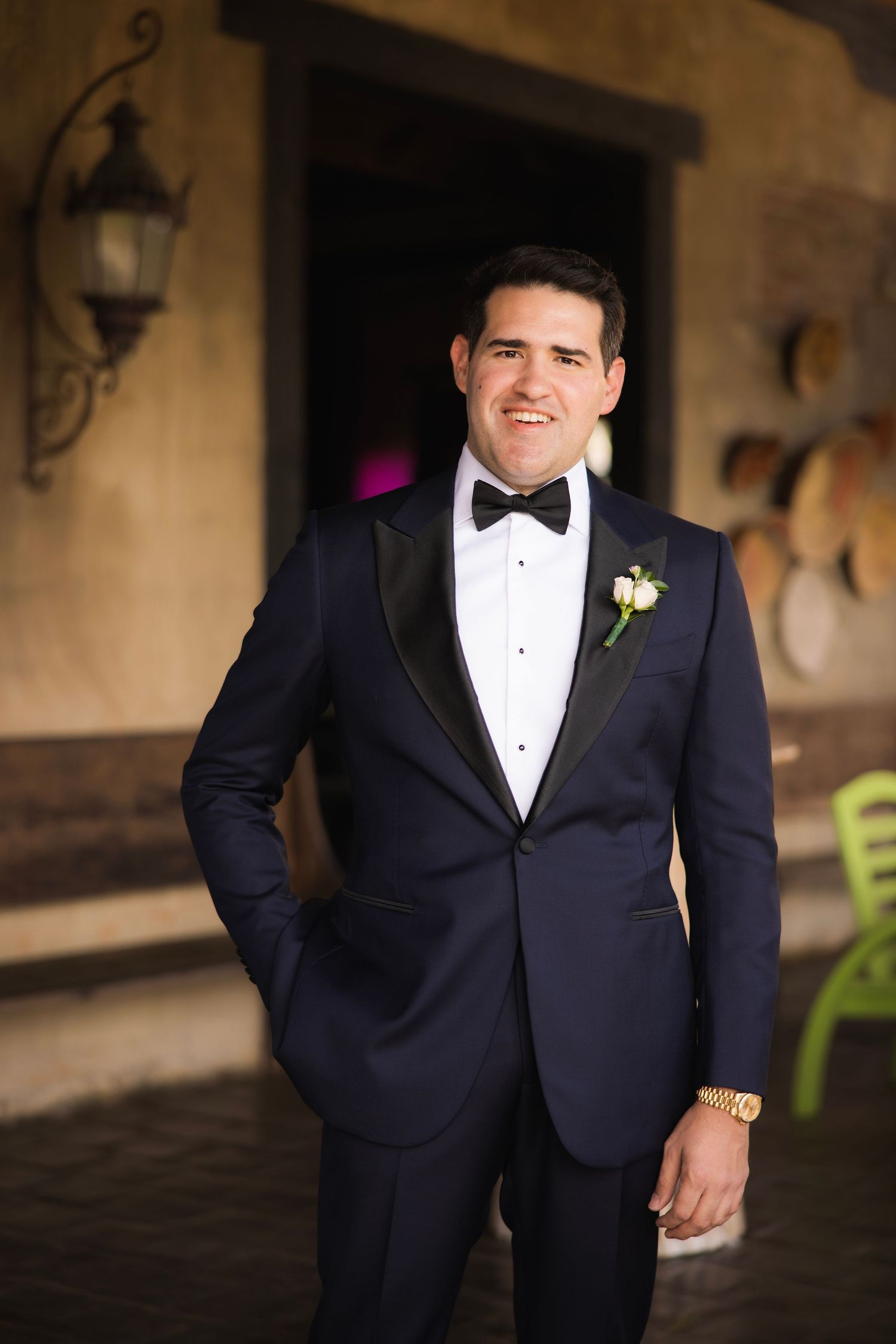 A formal black tuxedo with bowtie and boutonniere is shown in multiple detail shots.