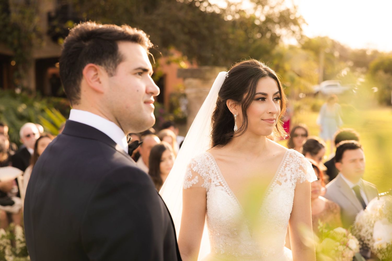 Wedding party celebrates during golden hour outdoors at sunset.