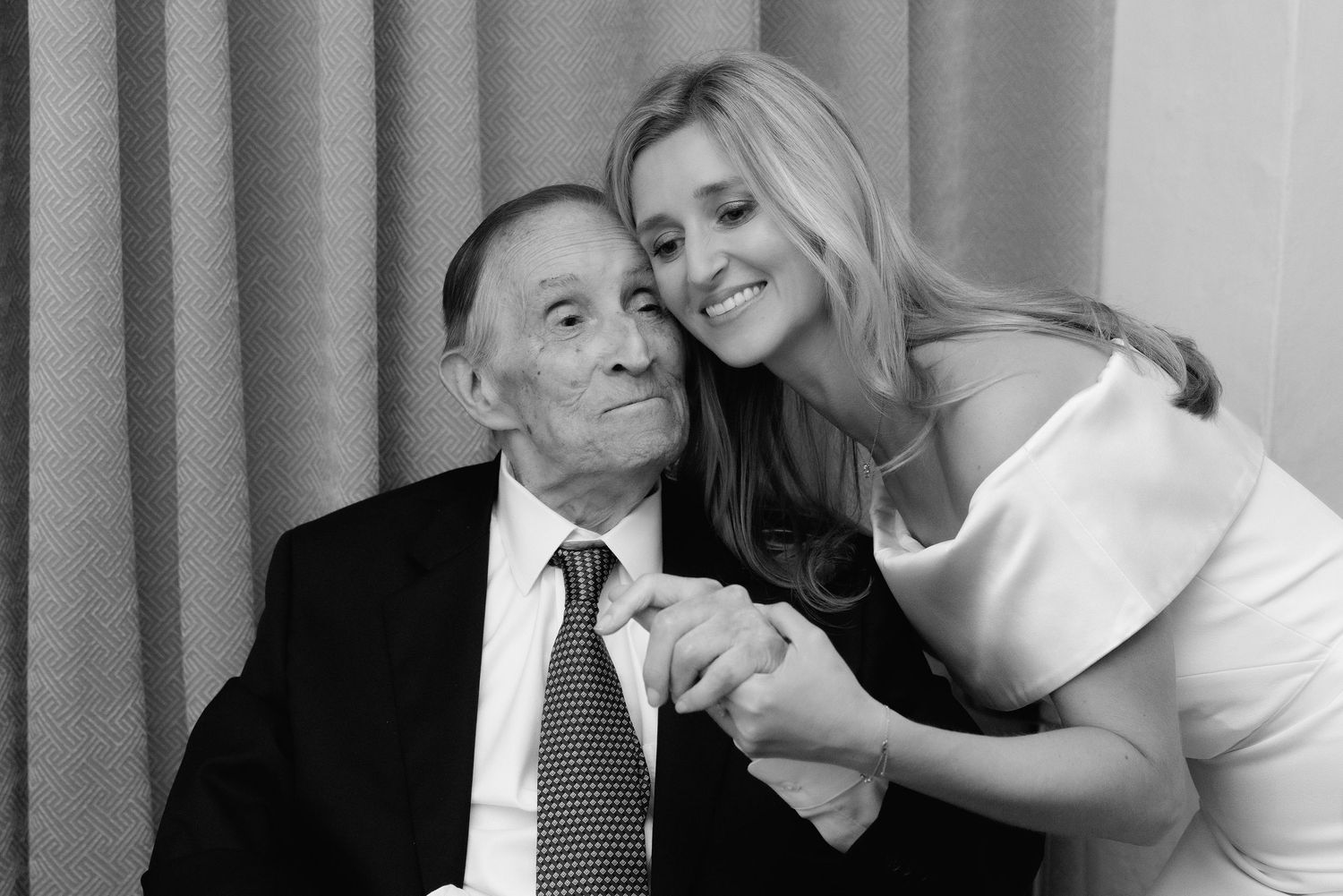 A series of six black and white photo booth style images showing two people posing playfully together.