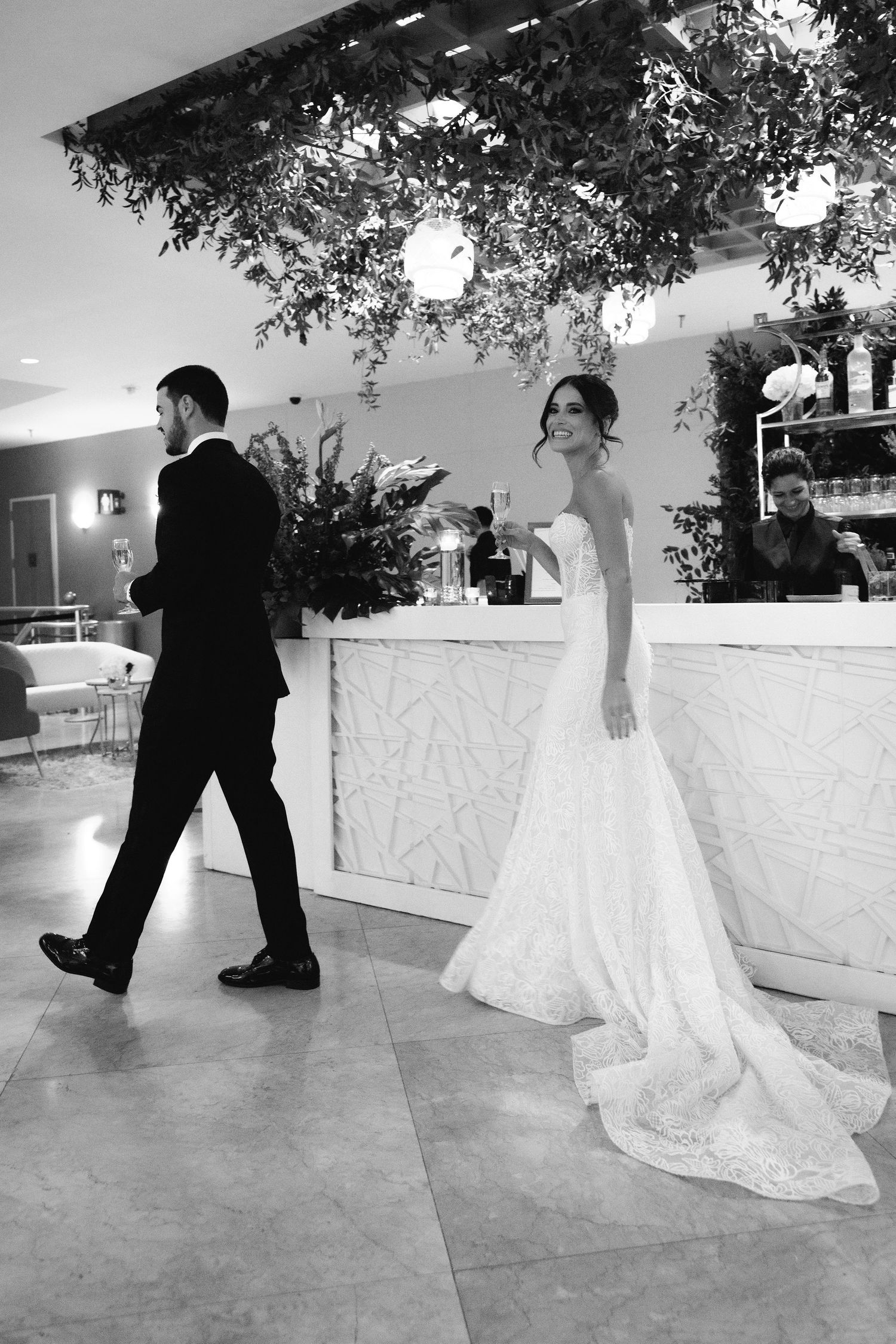 Series of black and white wedding photos showing couple dancing in elegant outdoor venue.
