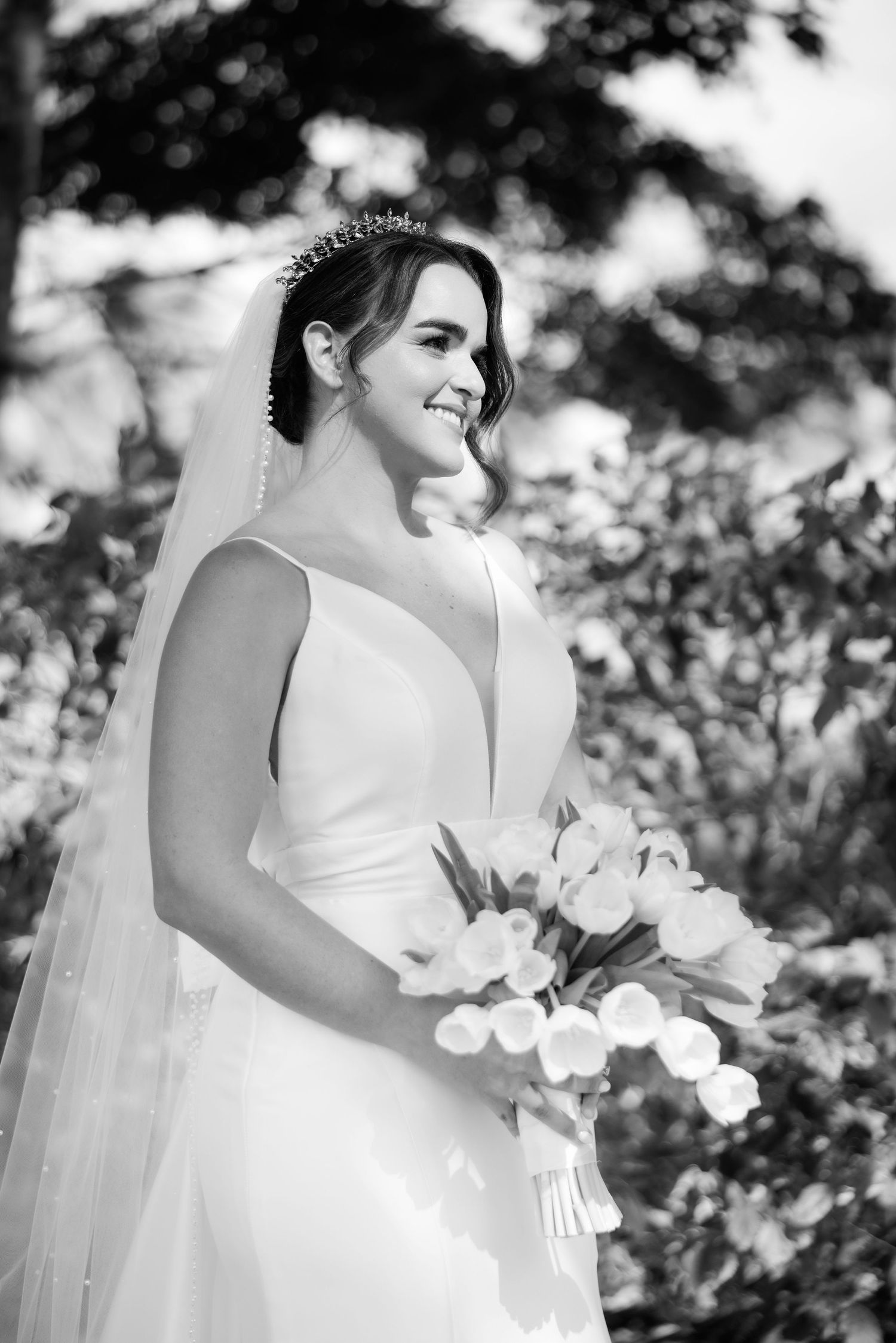 Black and white portrait series of a bride on her wedding day holding a bouquet of white orchids.