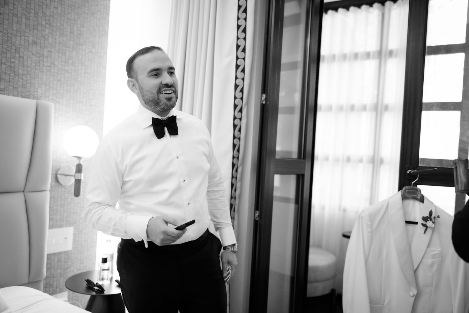 A black and white photo collage showing someone adjusting their tie and cuffs while getting dressed in formal attire.