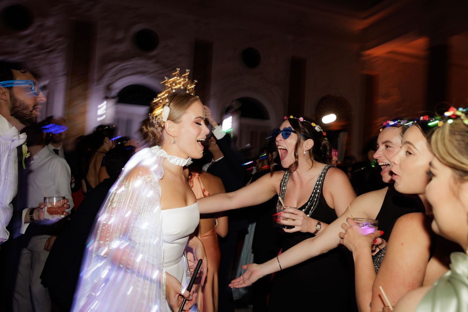A sequence of party photos showing people dancing together under dim lighting at a reception celebration.