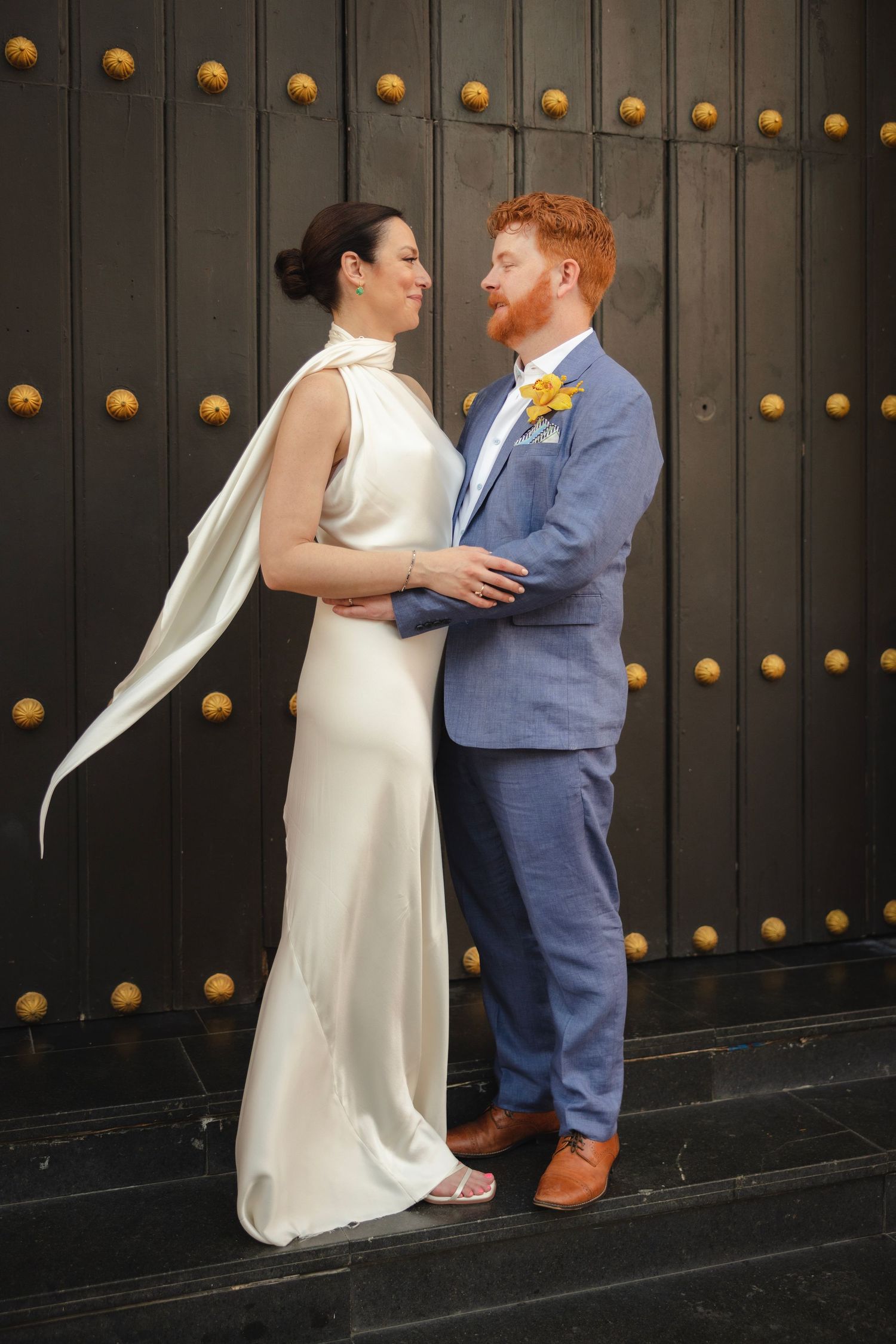 A creative wedding photo composition showing multiple poses against a dark wooden door with brass studs.