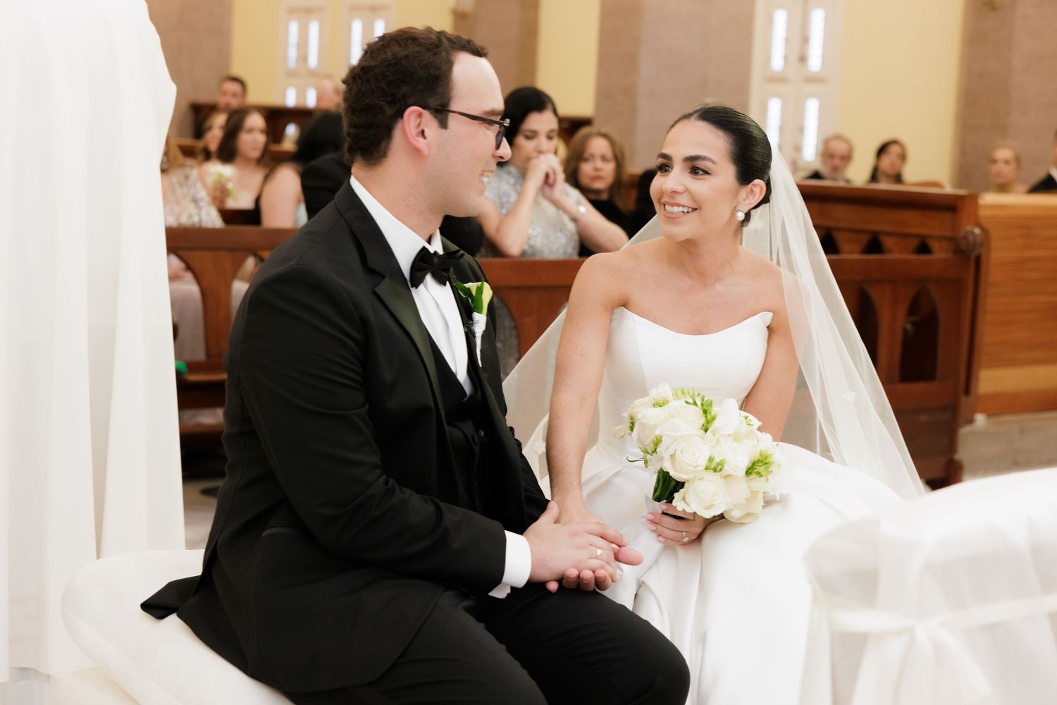 Intimate moment between newlyweds during their church wedding ceremony.