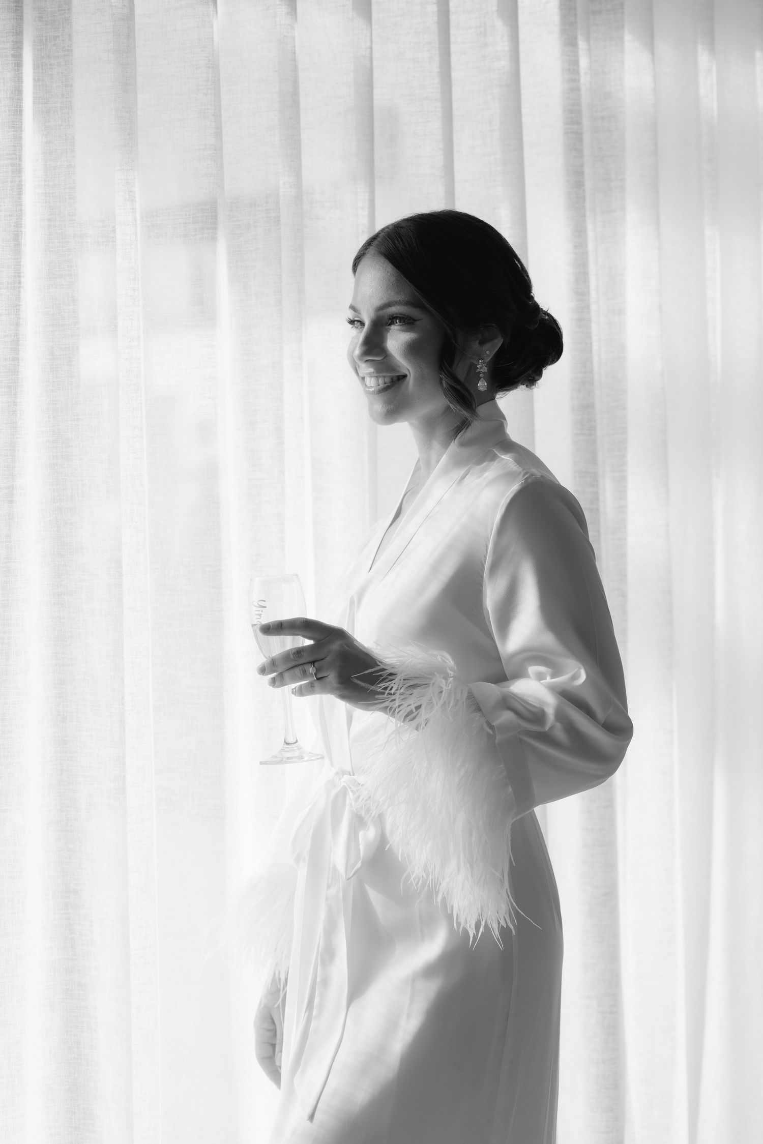 Artistic black and white portrait showing movement in a flowing white robe.