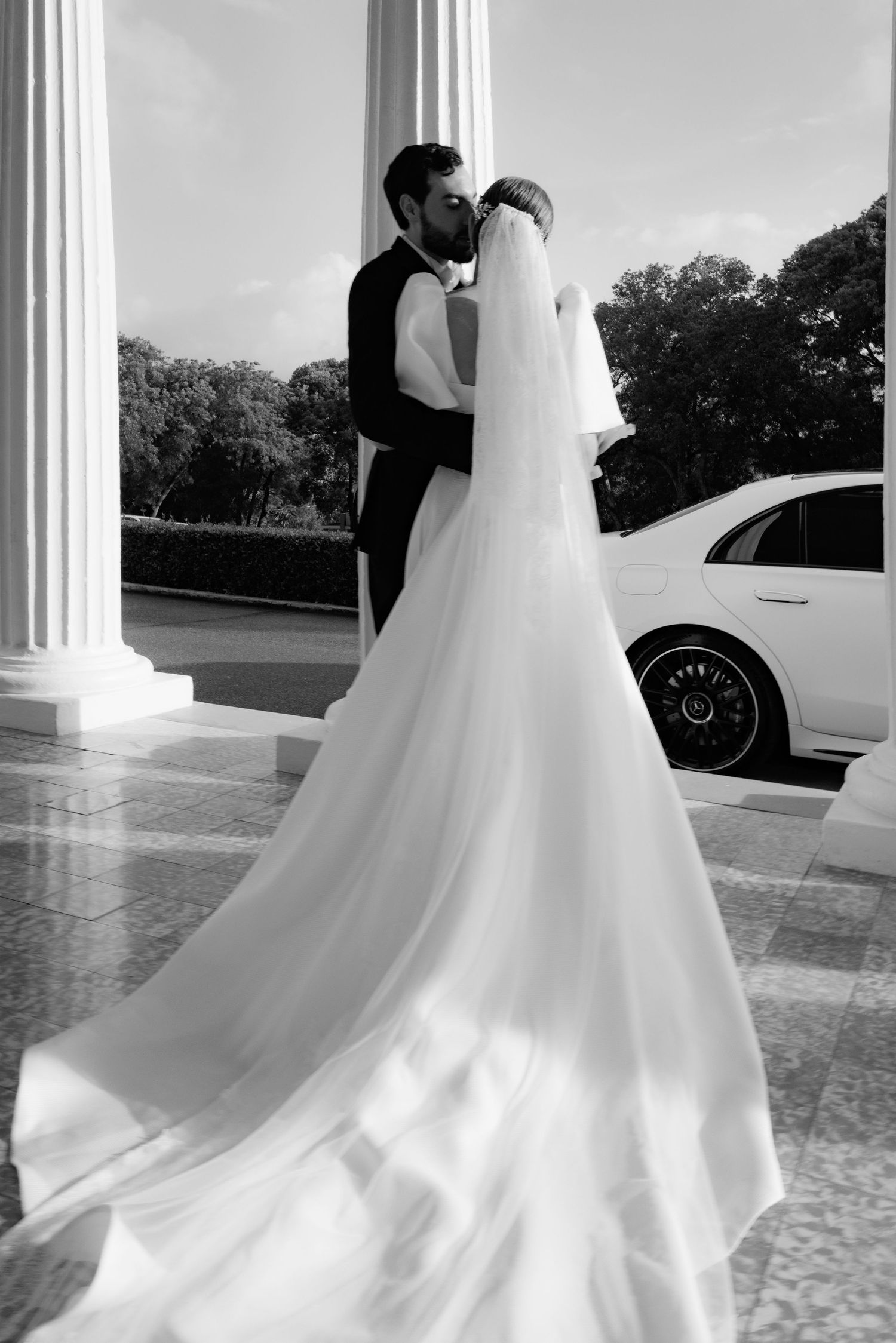 Series of white wedding dress photos showing flowing fabric and romantic details of a bride's gown at an elegant venue.