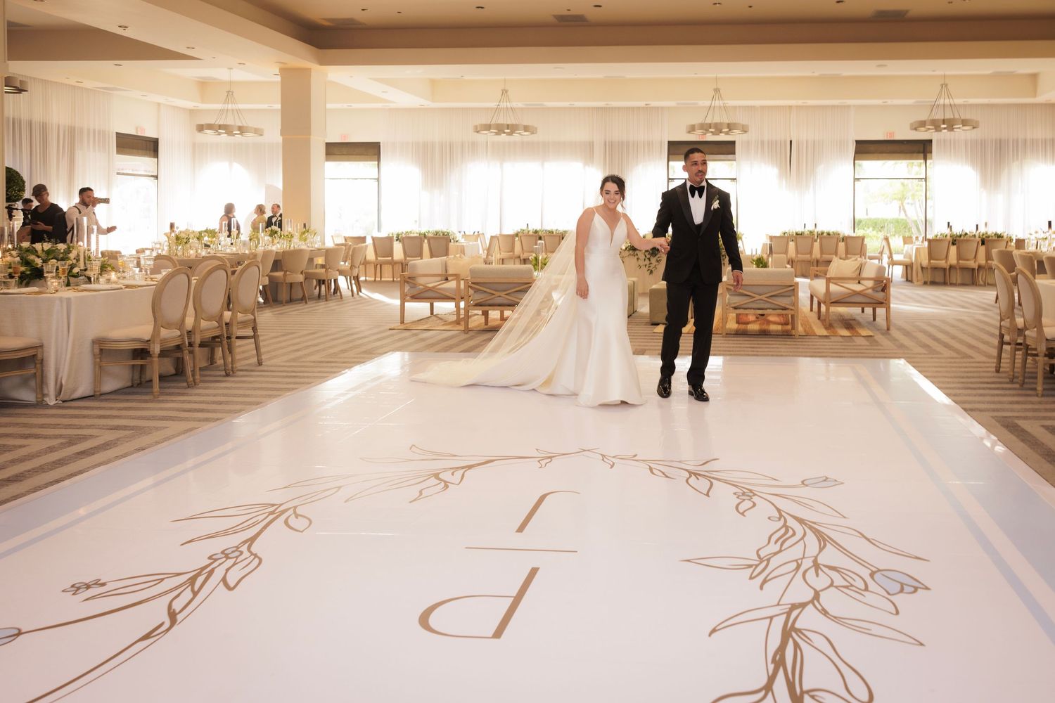 A collection of images showing a long wedding dress train creating artistic patterns on a white marble floor.