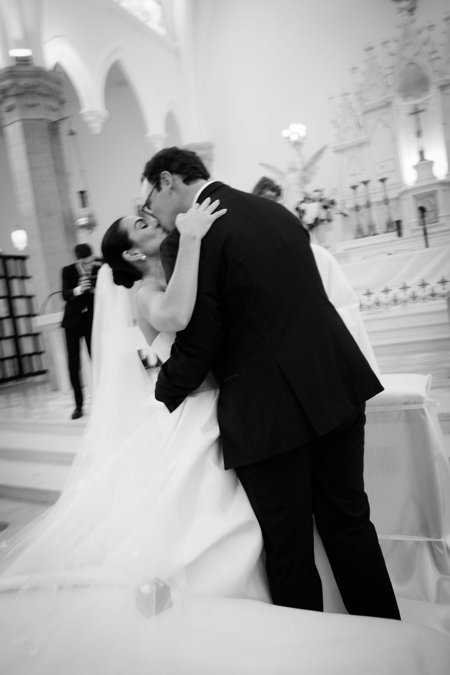 Romantic black and white dance sequence of newlyweds twirling in an ornate ballroom.