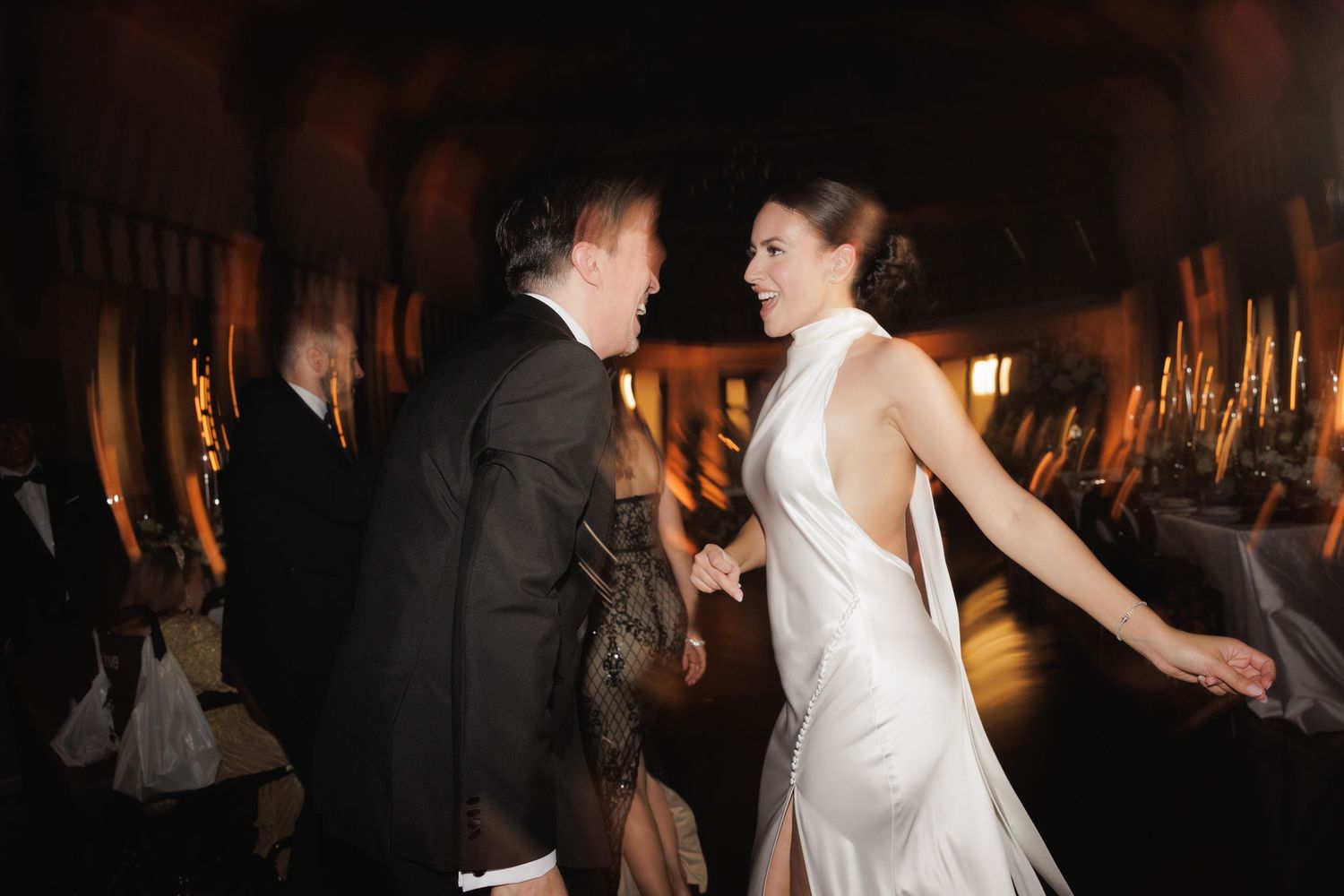 Intimate wedding dance photos with dramatic lighting and romantic atmosphere.