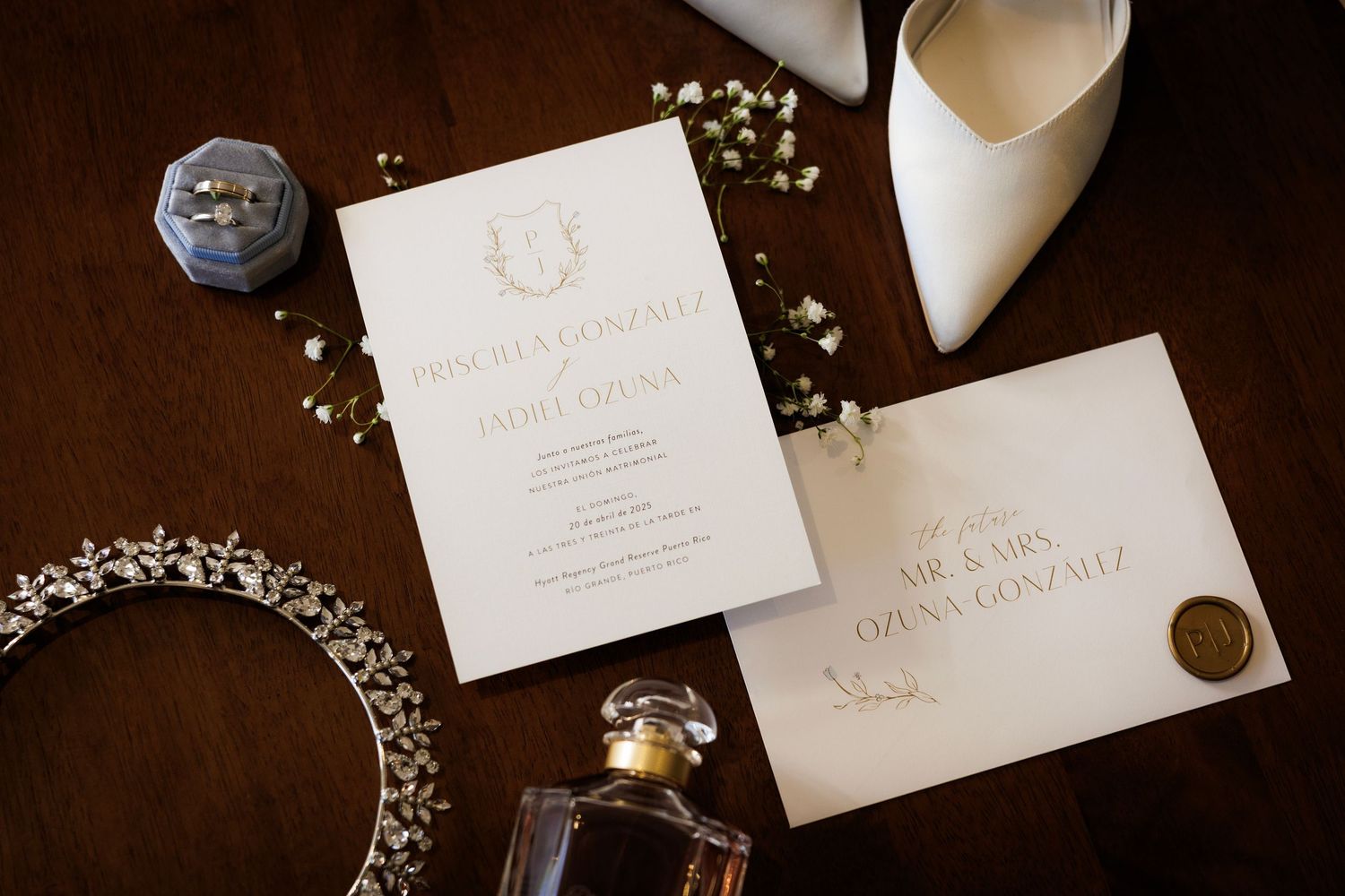 White paper wedding invitations and place cards with gold calligraphy and delicate floral details in an elegant arrangement.
