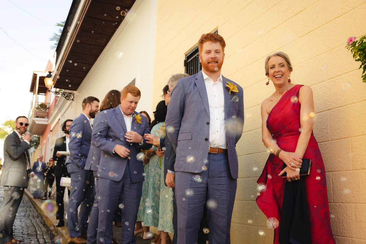 Group of people in professional attire standing and conversing during a business event or reception.