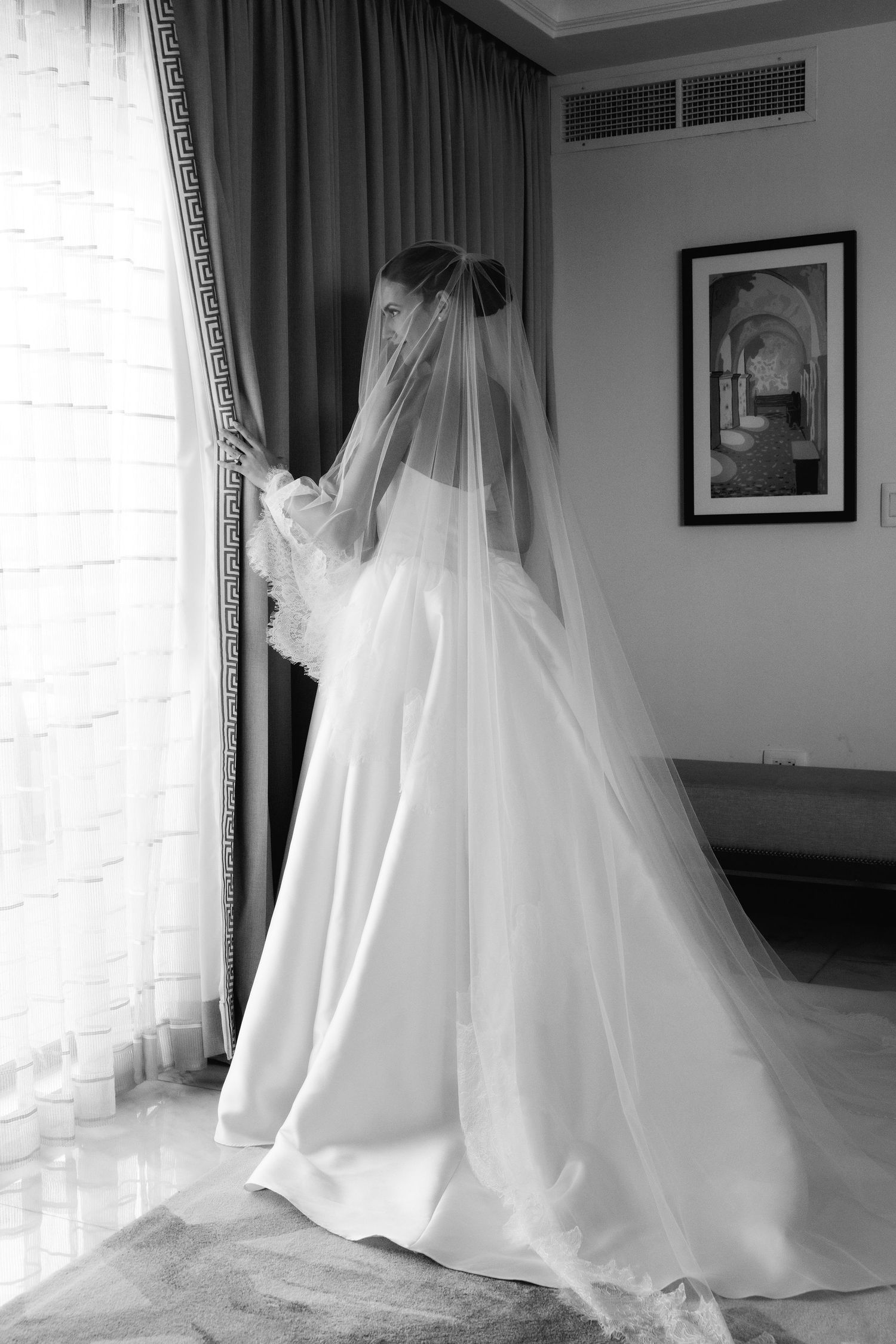 Elegant white wedding dress with flowing train and veil captured in dramatic lighting from different angles.