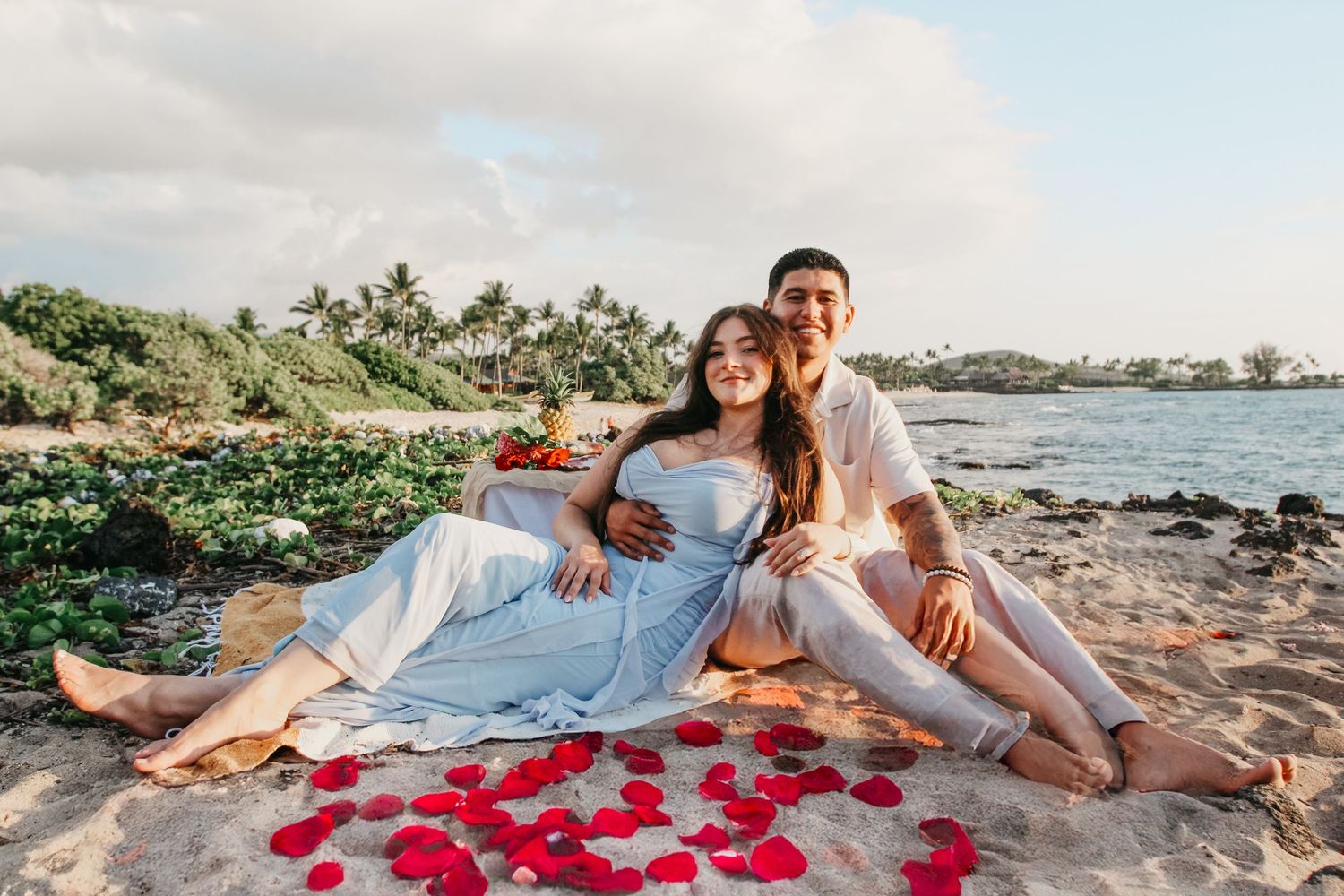 Big Island Hawaii beach proposal setup with red roses at sunset